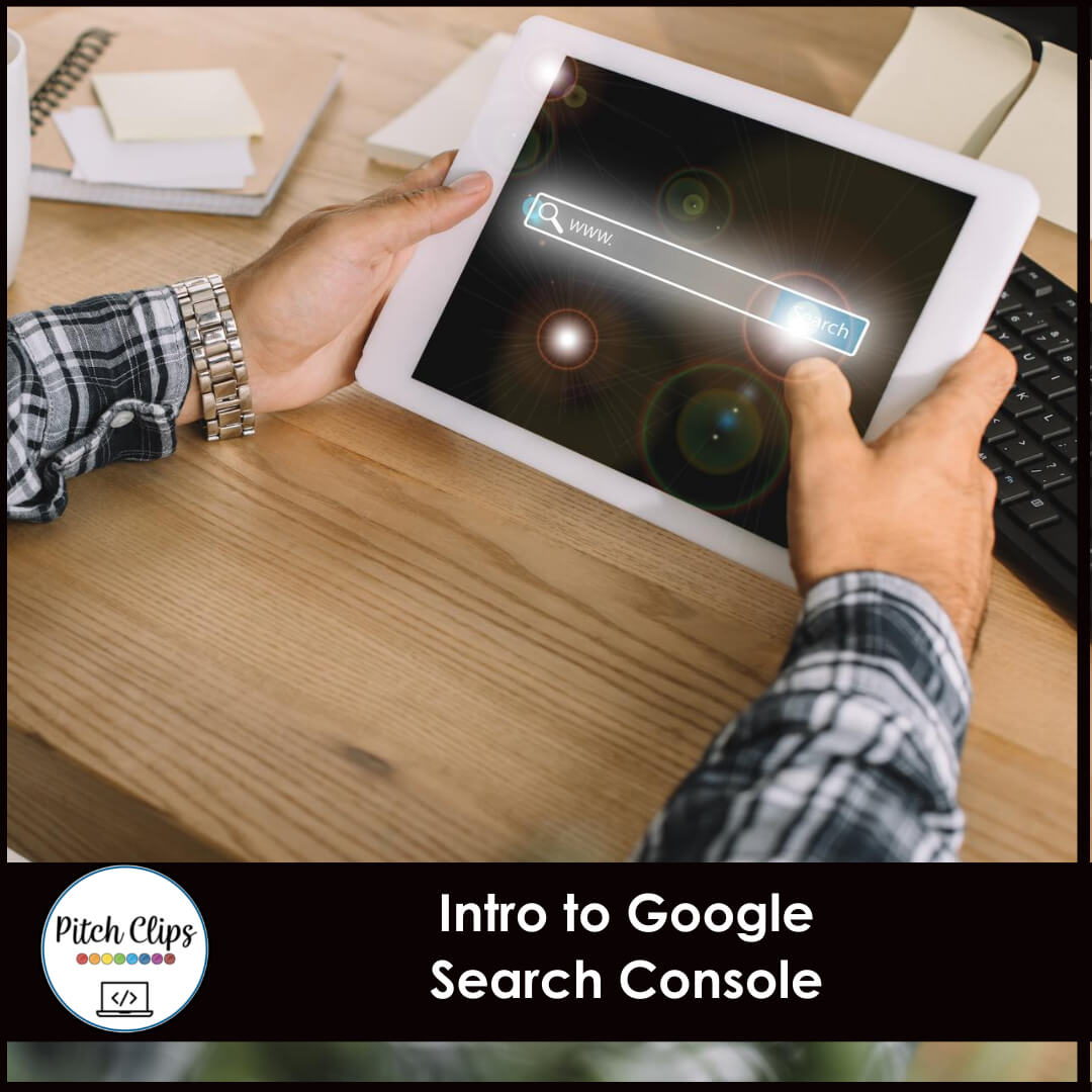 A person holding a tablet displaying a search engine interface. Nearby are a keyboard and notepads on a wooden desk. Titled "Intro to Google Search Console" with a "Pitch Clips" logo at the bottom left.