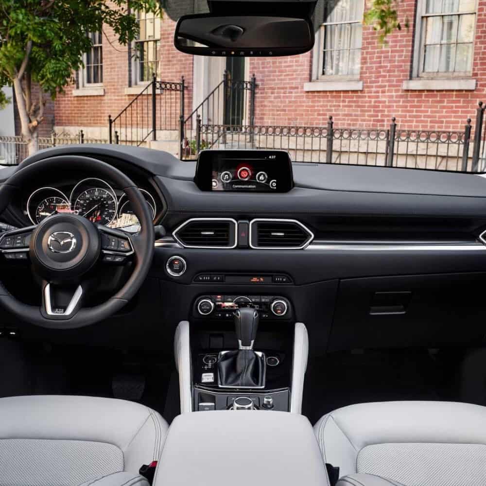 Interior dashboard and steering wheel of Mazda CX-5 2017 with custom interior accessories.