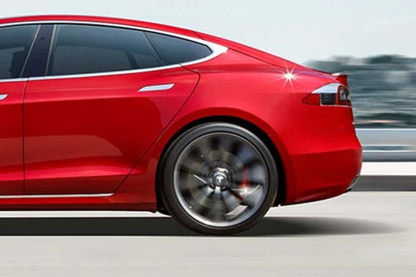 Impact area of Tesla Model-S rear wheel showing damage.