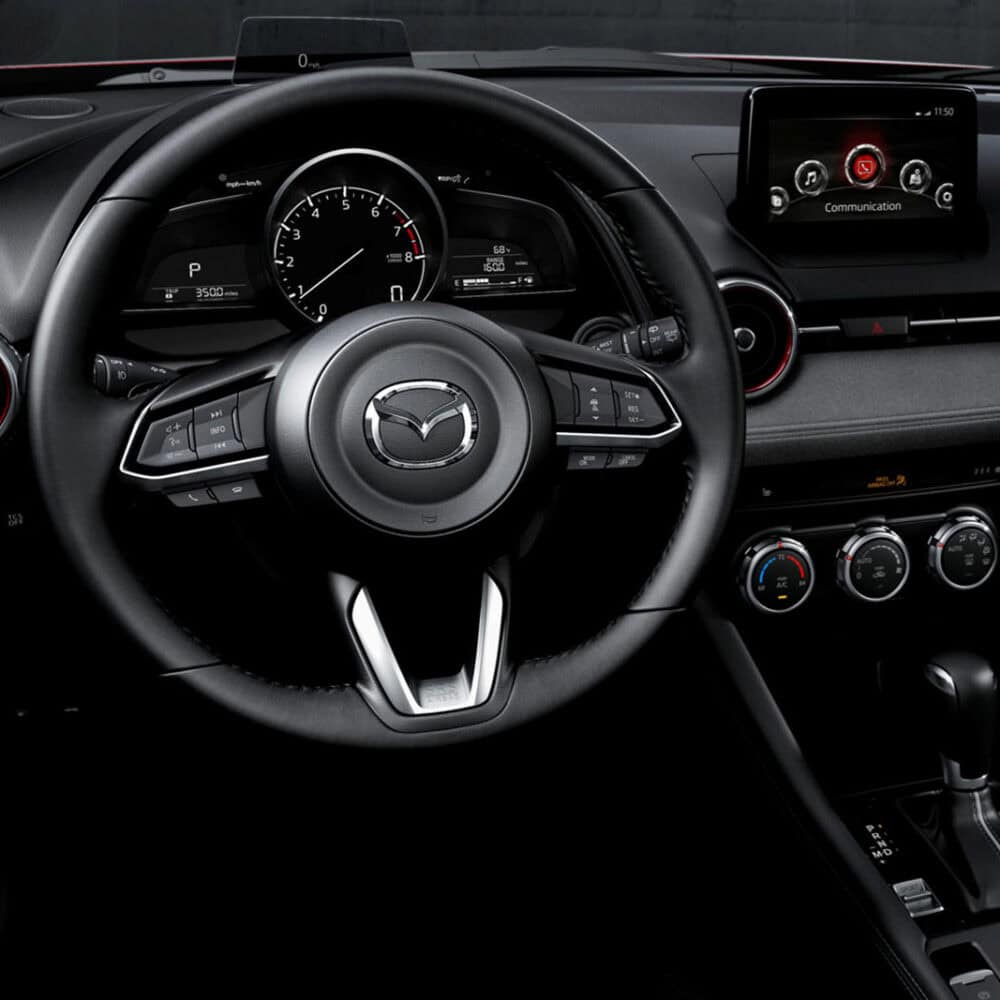 Mazda CX-3 interior dashboard and steering wheel with modern features.