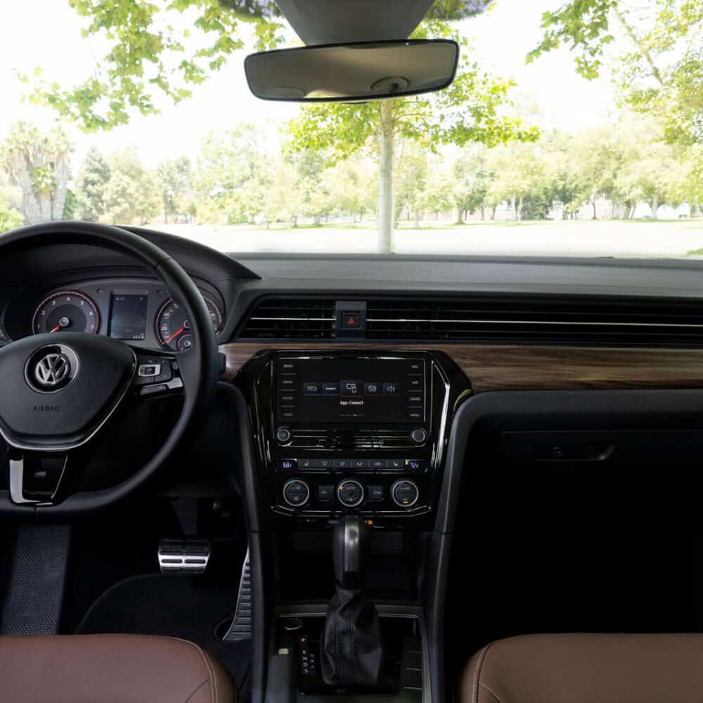 Volkswagen Passat 2019 interior dashboard and steering wheel with wood trim accents.