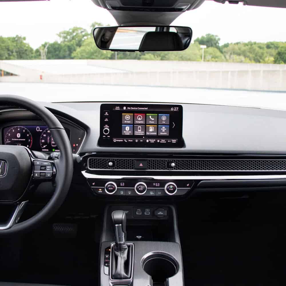 Interior dashboard of Honda Civic with touchscreen infotainment and sleek design.