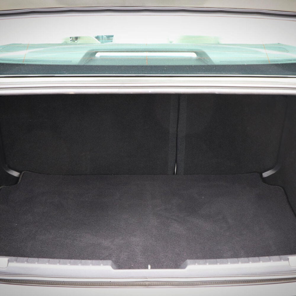 Mazda 3 trunk cargo area with protective lining and accessories.