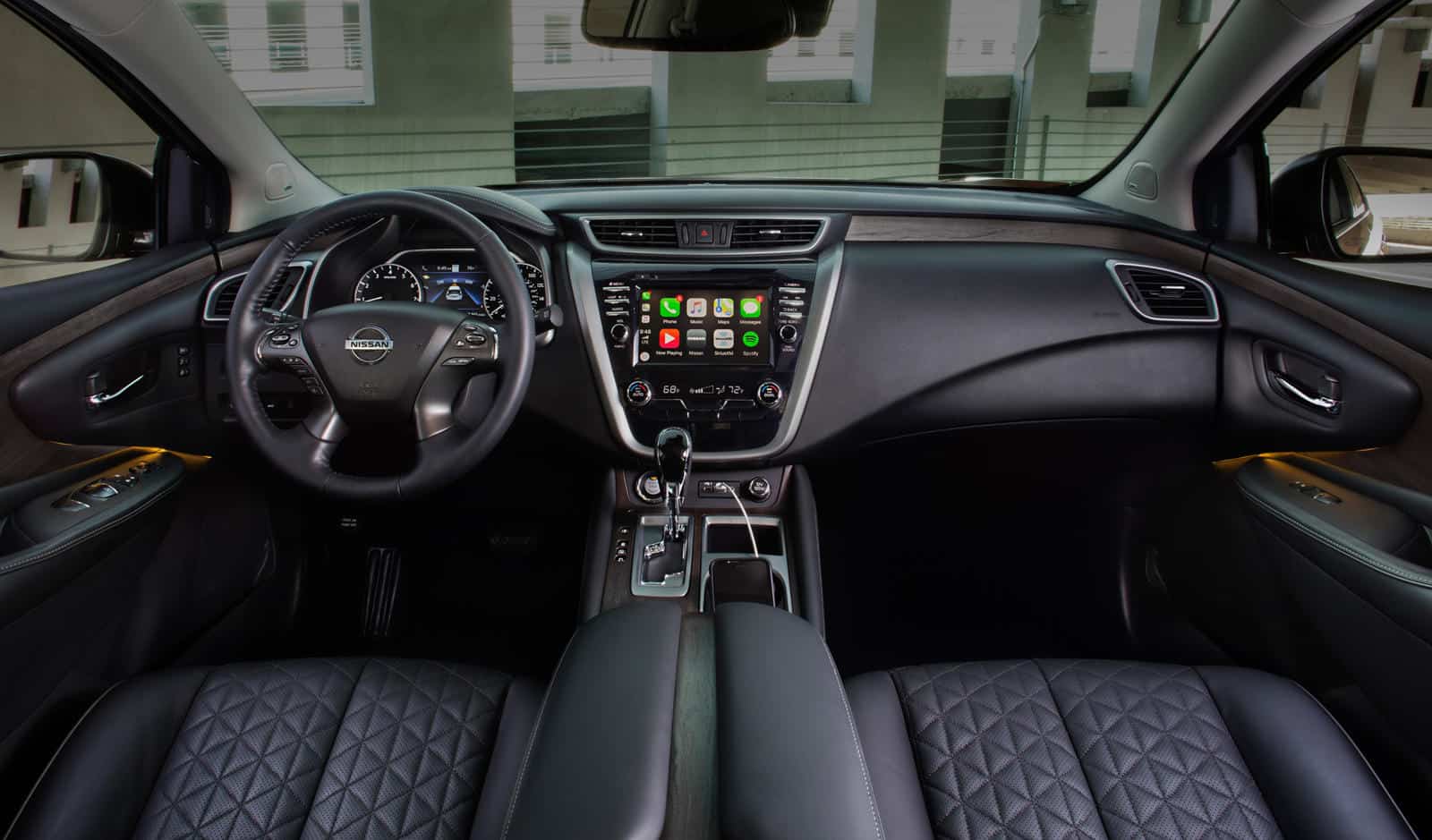 Interior view of Nissan Murano showcasing dashboard and infotainment system with screen protector.