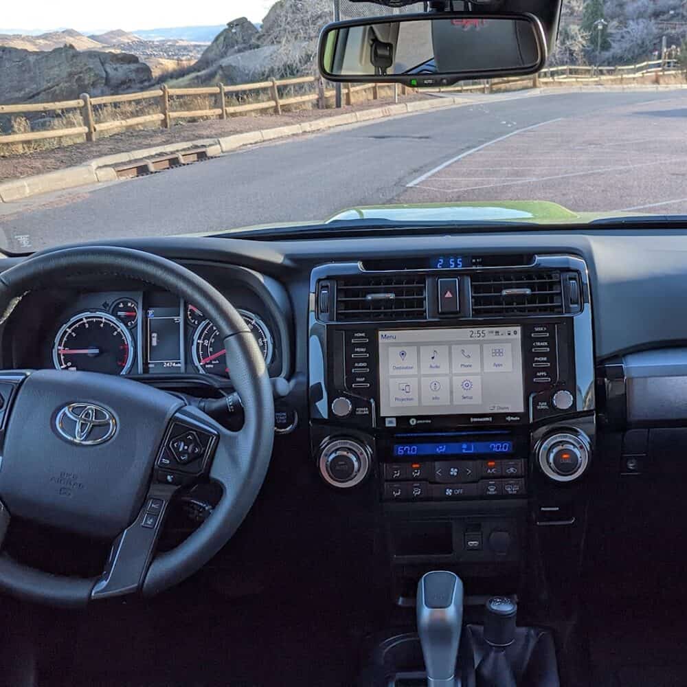 Interior dashboard and steering wheel of Toyota 4Runner with custom interior accessories.