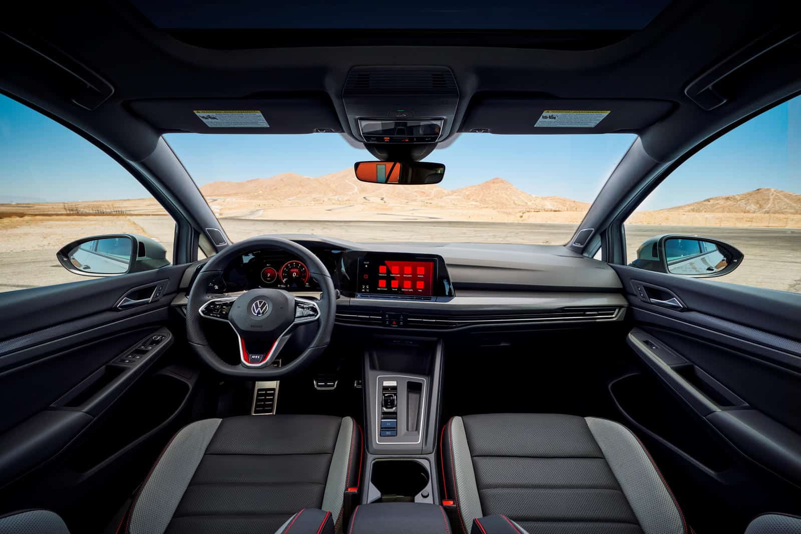 Interior dashboard and steering wheel of Volkswagen Golf.