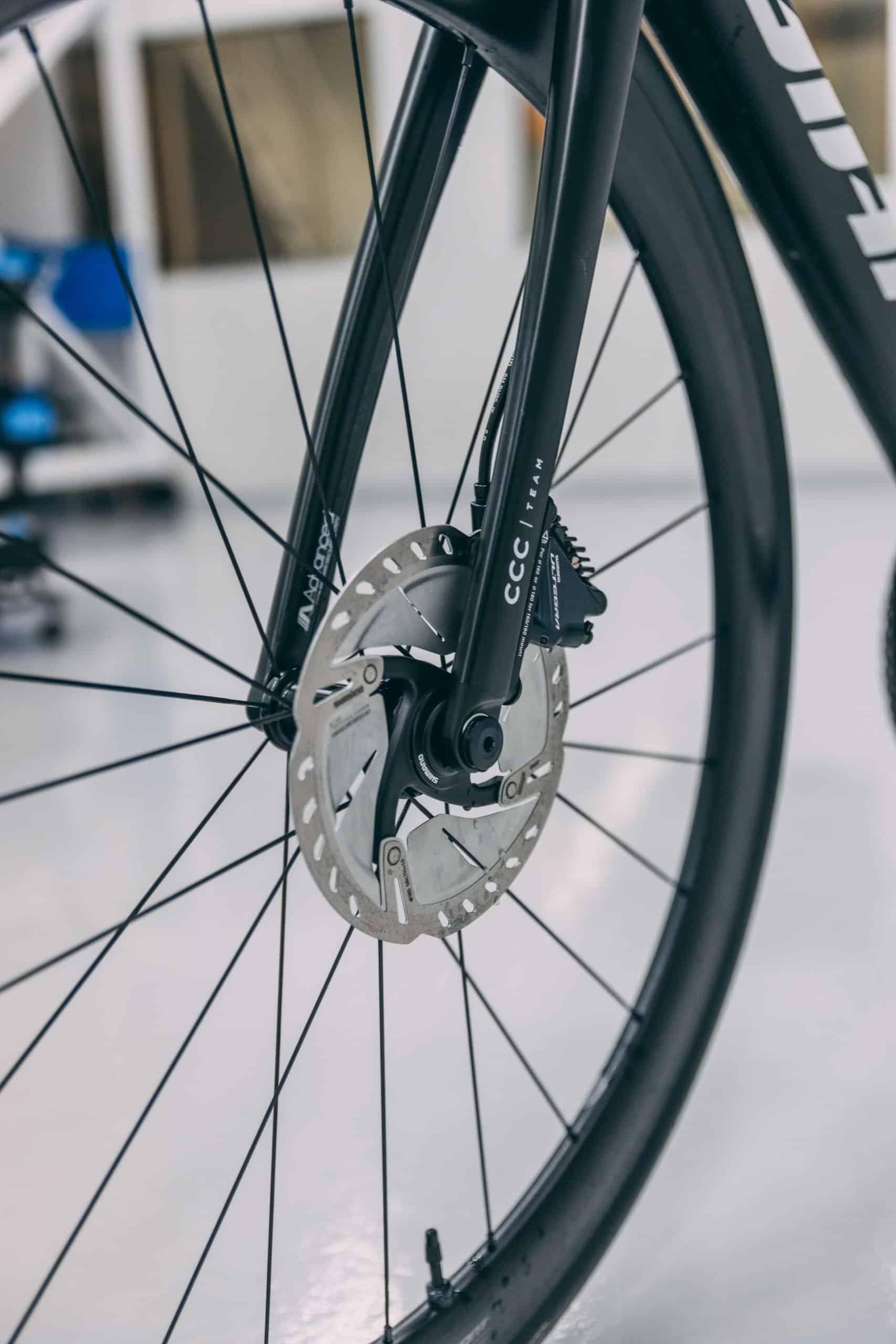 Close-up of TCR bike frame with protective film on the fork and wheel.