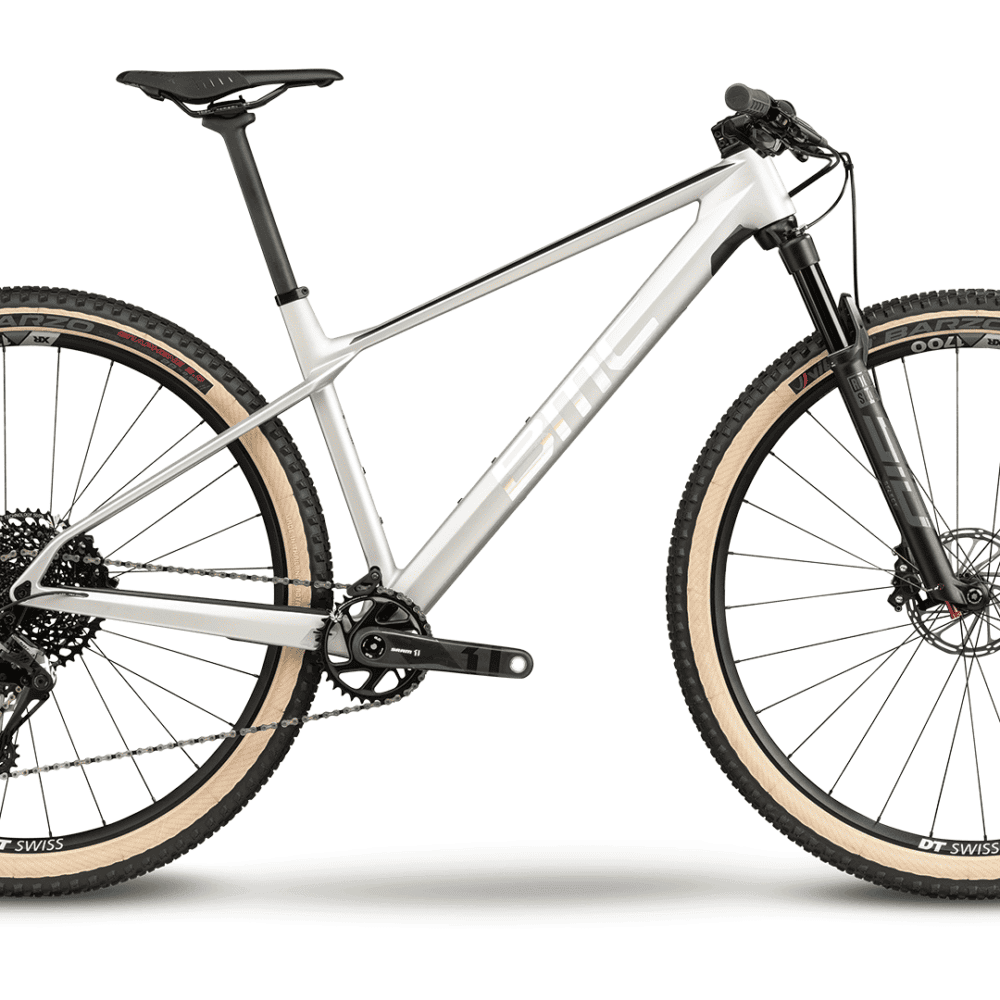 Modern mountain bike with front suspension, black frame, and knobby tires for trail riding.