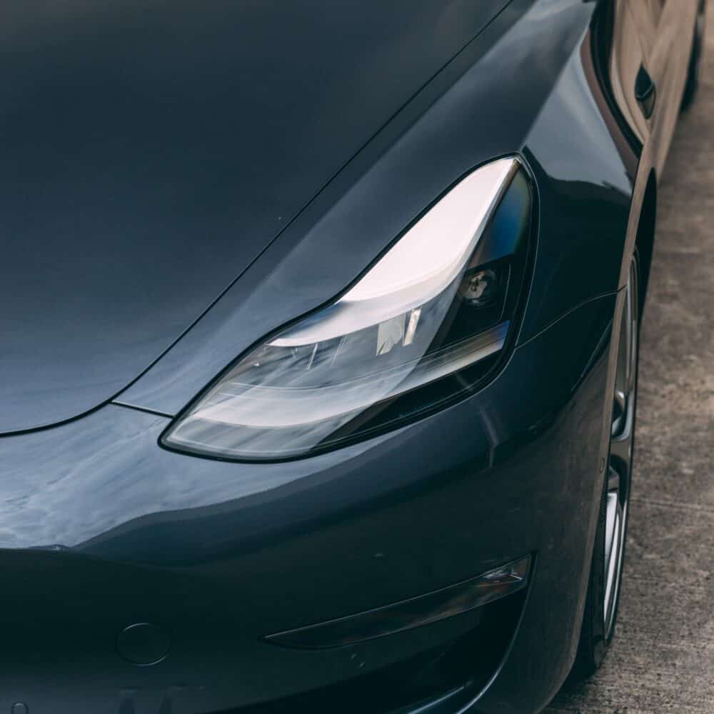 Tesla Model S front headlight with modern automotive lighting technology.