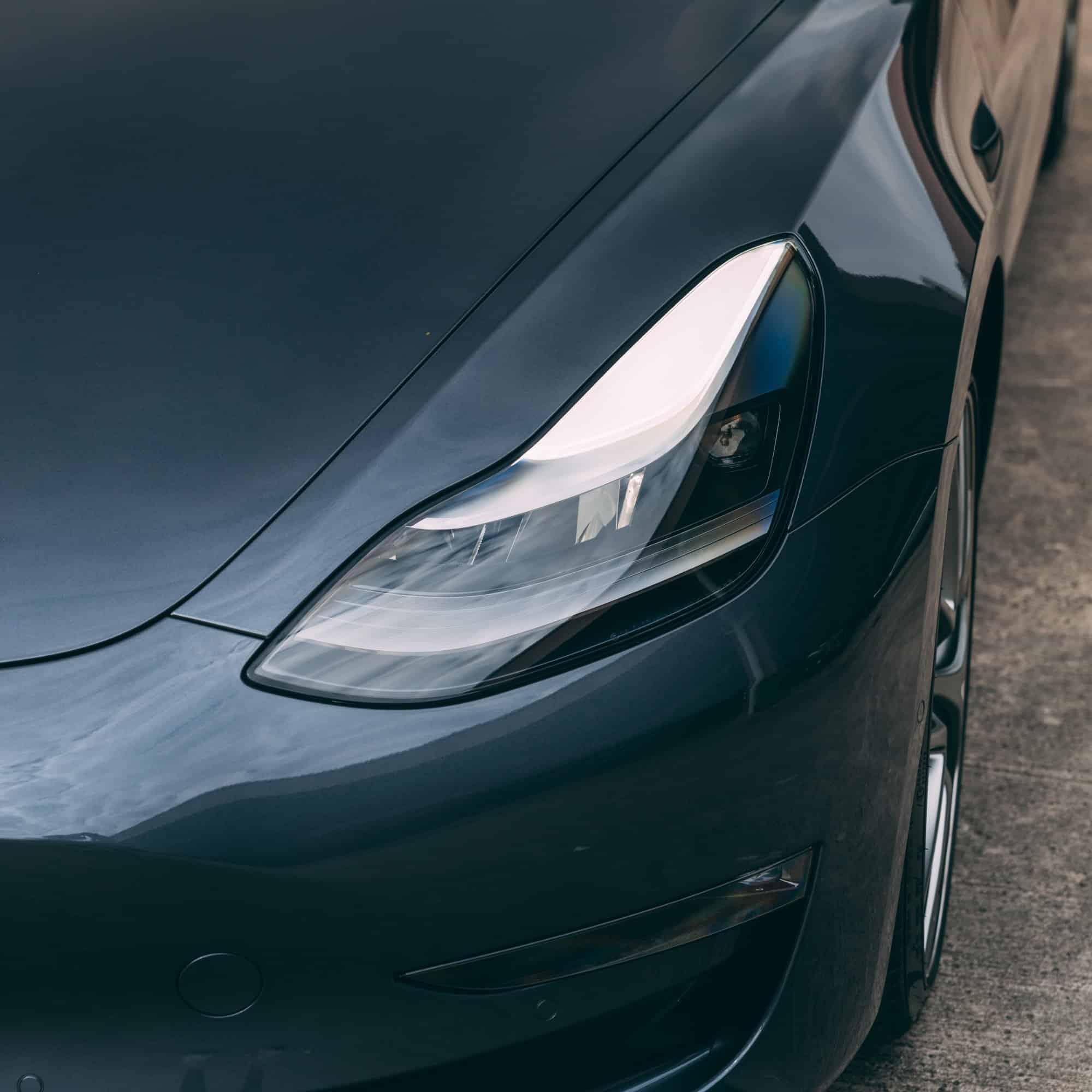 Tesla Model S front headlight with modern automotive lighting technology.