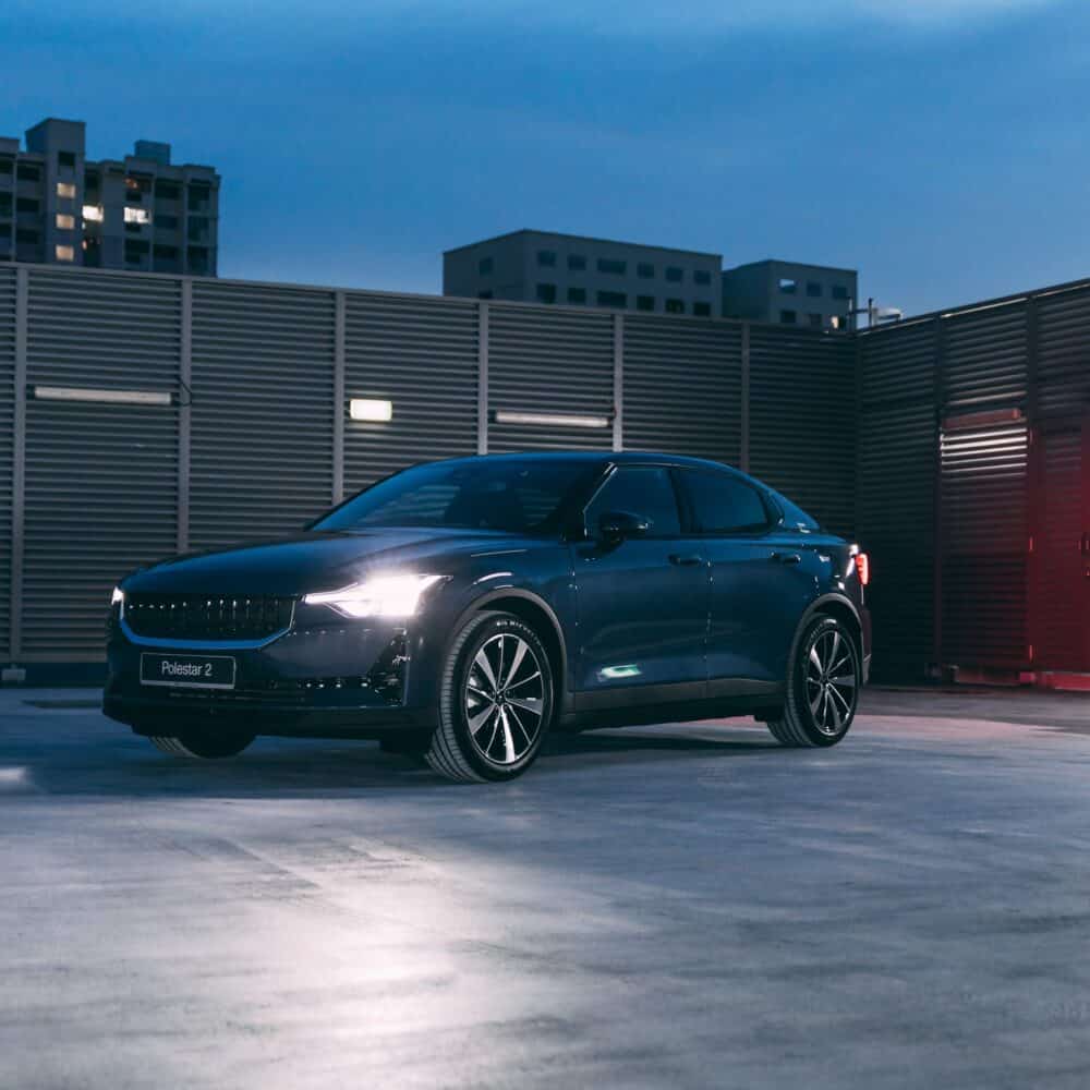 Modern Polestar 2 electric vehicle parked on rooftop at dusk, showcasing sleek design and advanced t.