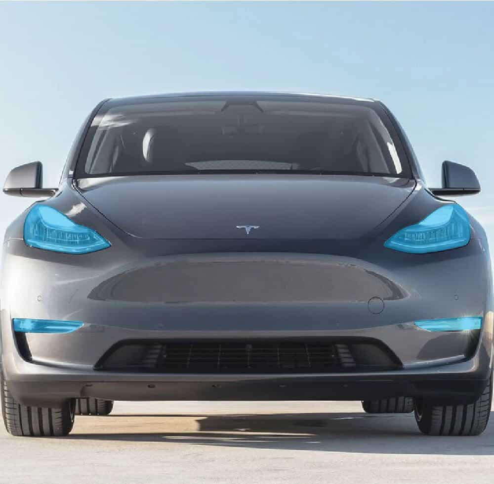 Modern Tesla Model 3 electric vehicle on a clear day.