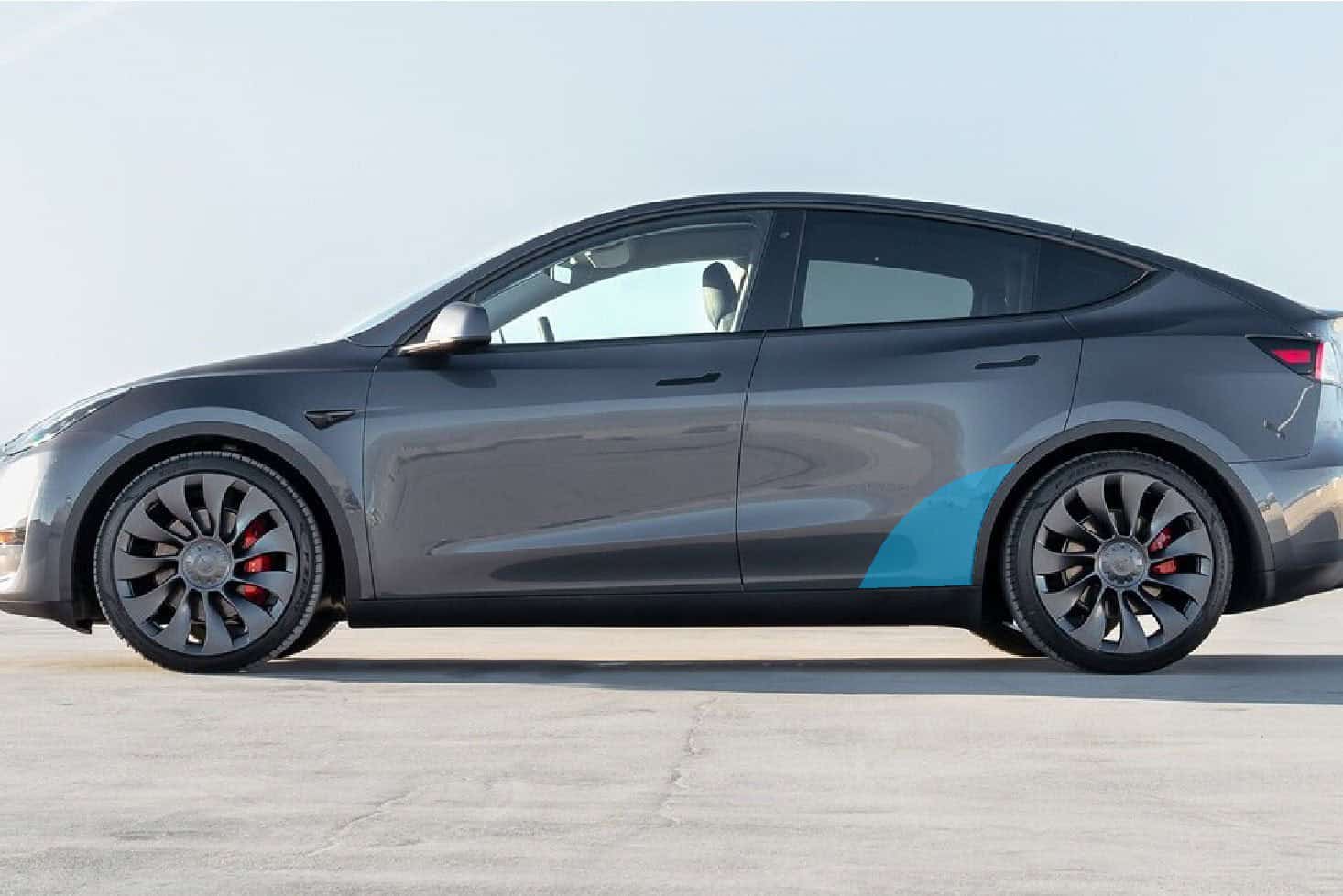 Modern Tesla Model 3 electric vehicle with sleek design and black finish.