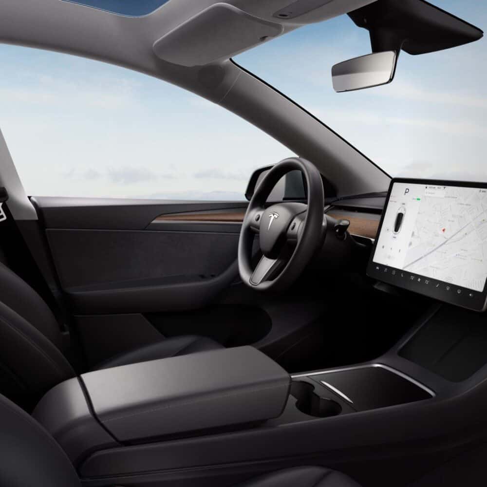 Tesla Model 3 interior showcasing a sleek dashboard and advanced touchscreen control system.