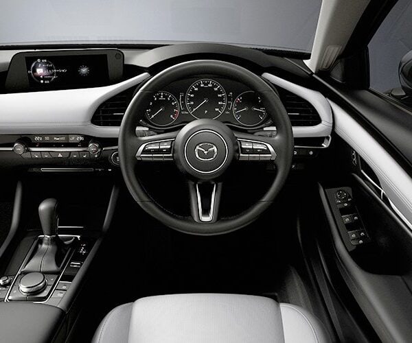 Interior dashboard and steering wheel of Mazda 3 2023 model.