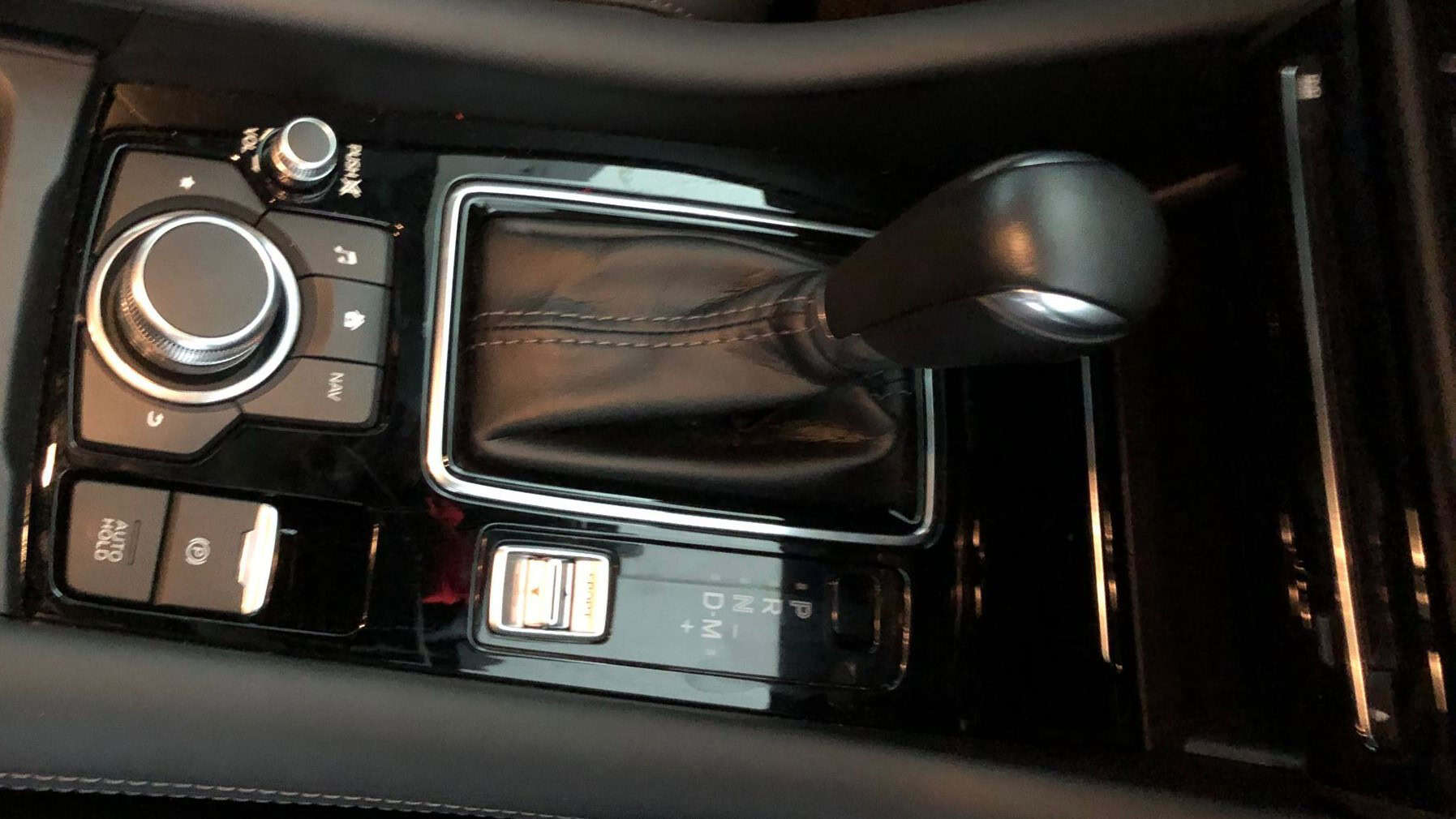Interior gear shift area of Mazda 6 with custom upgrade kit.
