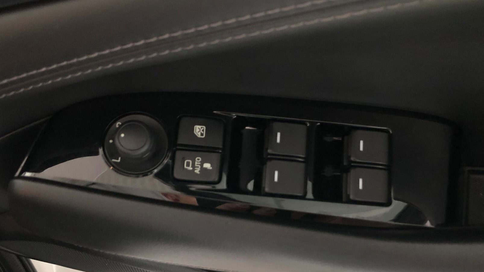 Mazda 6 interior control panel with window switches and lock buttons.