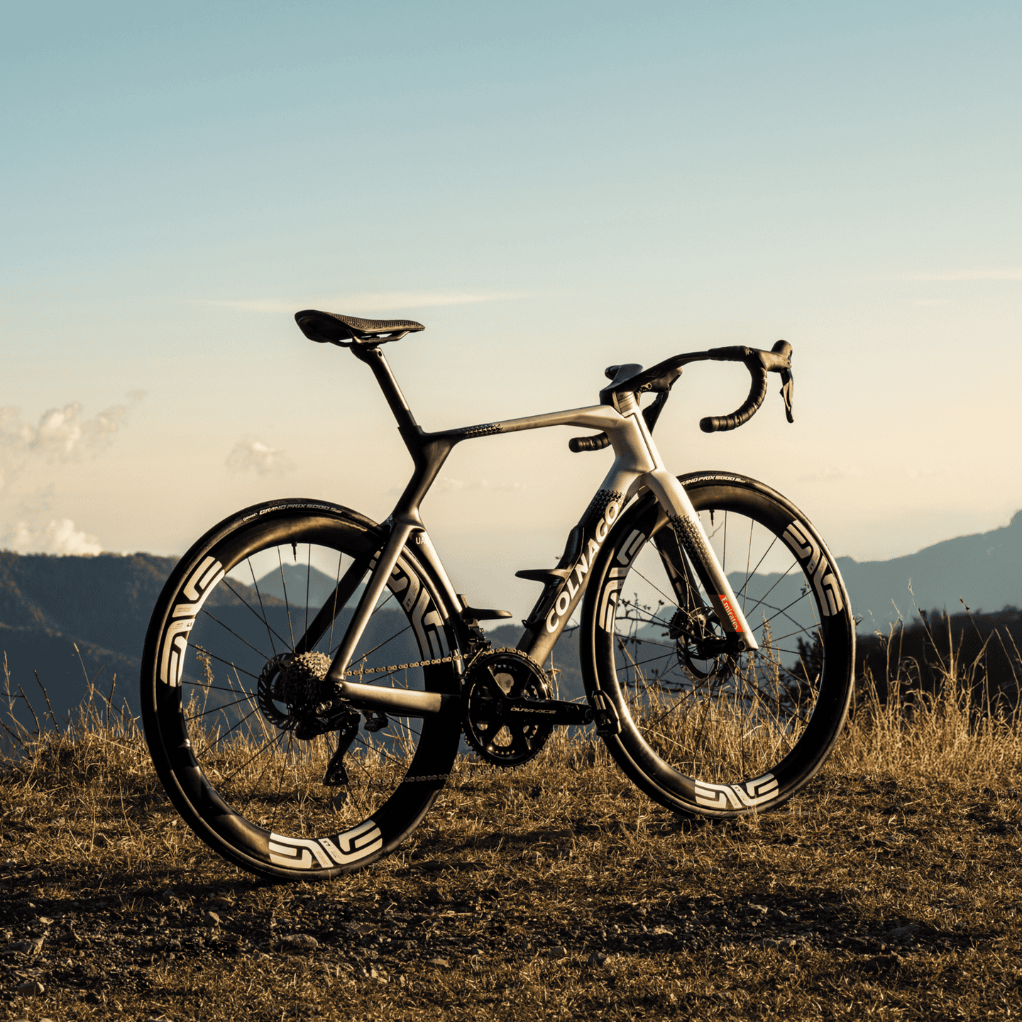 High-performance Colnago Y1RS road bike on scenic mountain background.