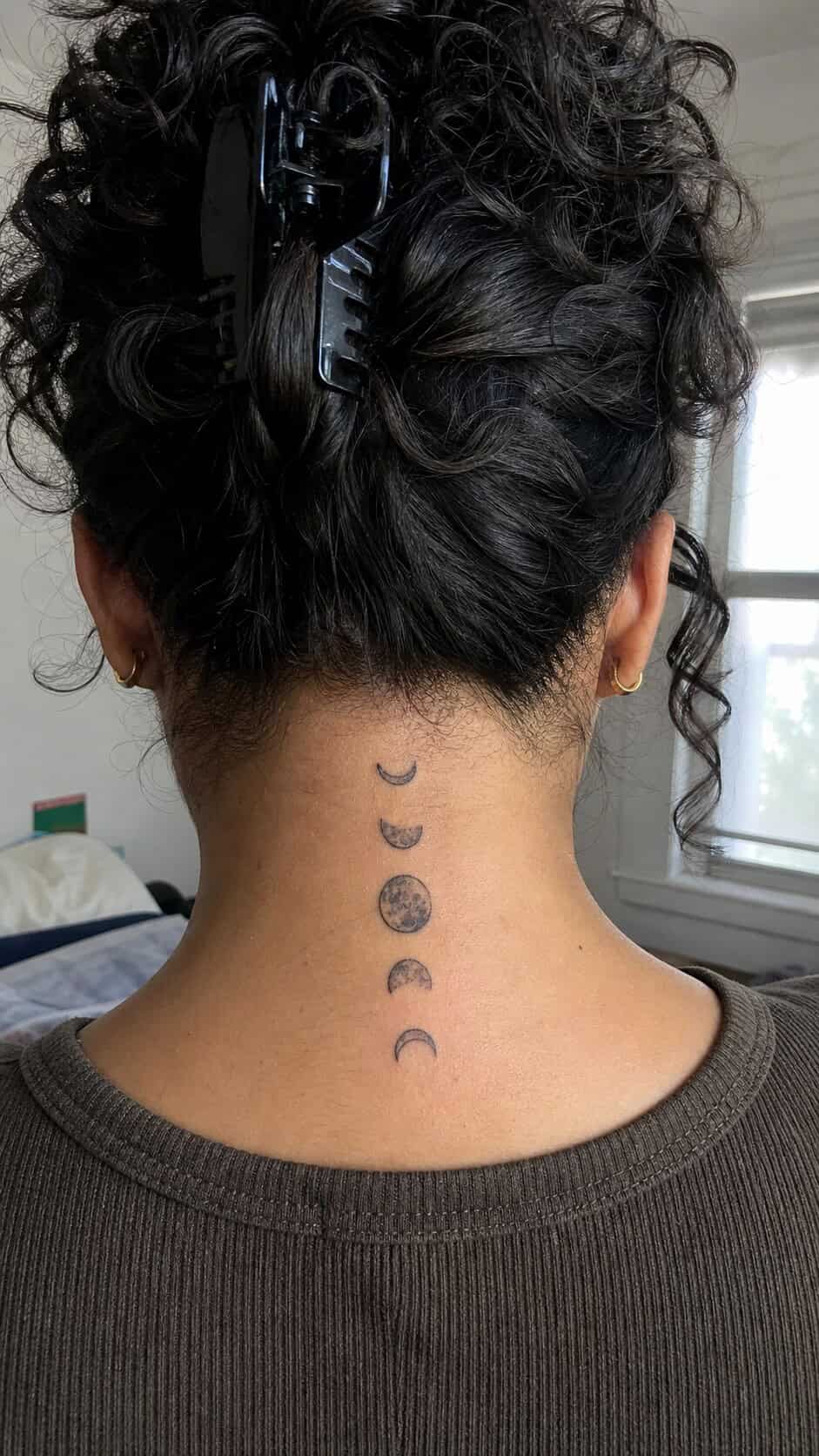 Minimalist Moon Phases neck tattoo idea