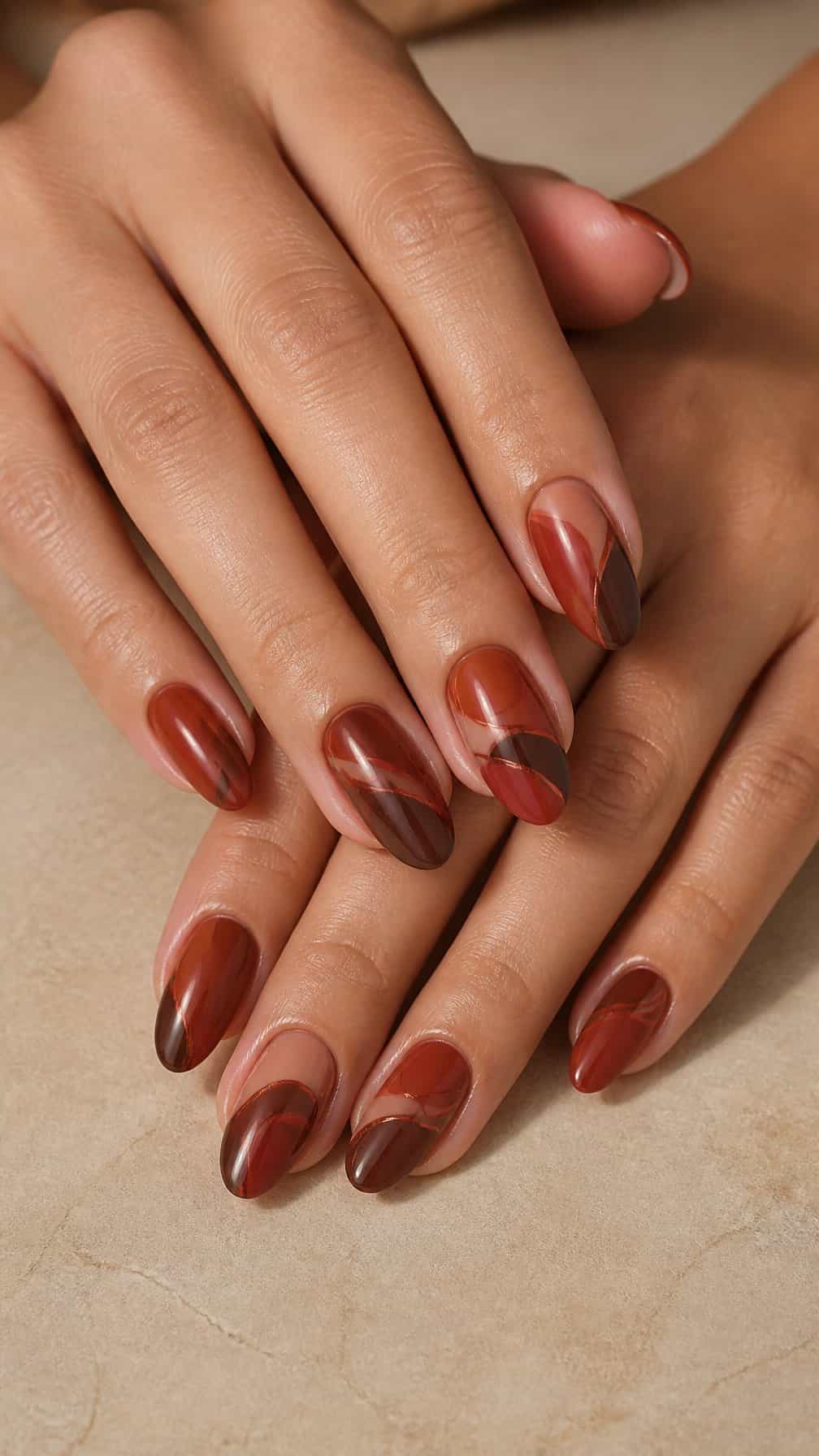 Close-up of manicured hands with dark terracotta nails decorated with curved abstract wave patterns.