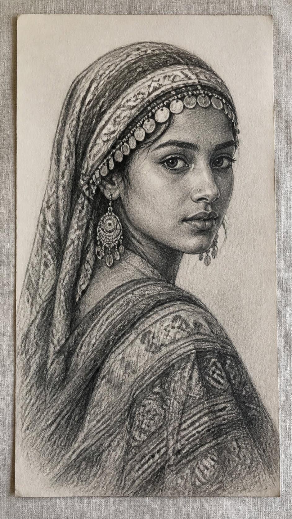 20 Girl Drawing Concepts to Elevate Your Art Game 44 Hand-drawn ethnic beauty in graphite drawing on textured paper, shown in a straight overhead view — study 2