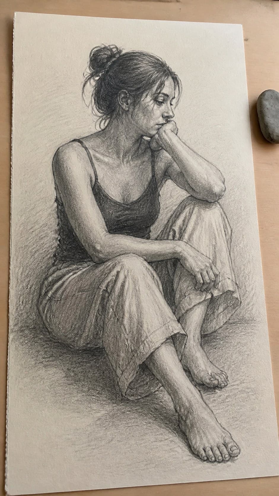 19 Creative Body Sketch Ideas Every Artist Should Try 5 Hand-drawn contemplative seated figure in graphite drawing on textured paper, shown in a close overhead crop — study 2