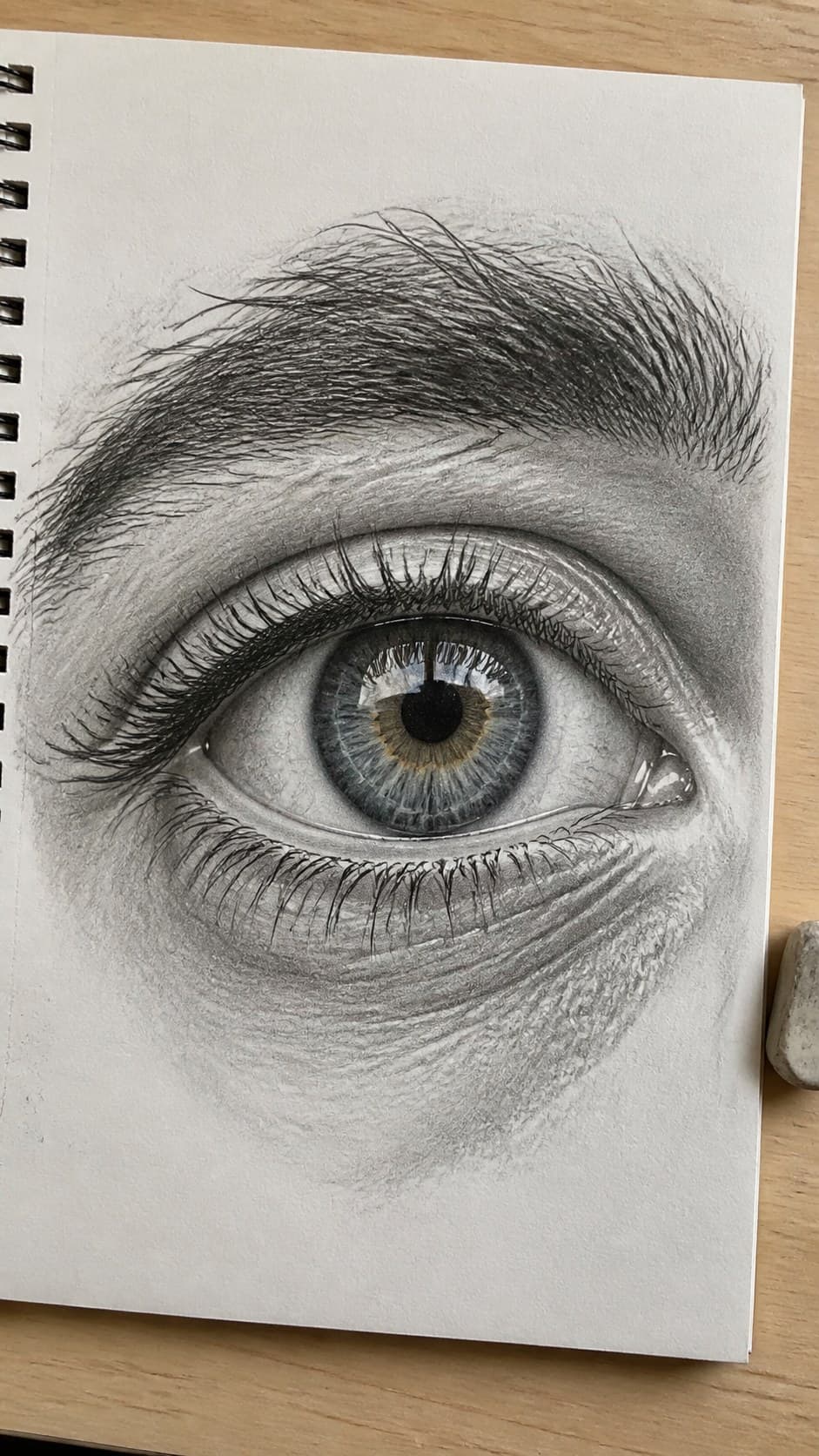 20 Challenging Drawing Ideas to Push Your Artistic Limits 4 Hand-drawn hyper-realistic eye in mixed-media hand drawing on textured paper, shown in a close overhead crop — study 1