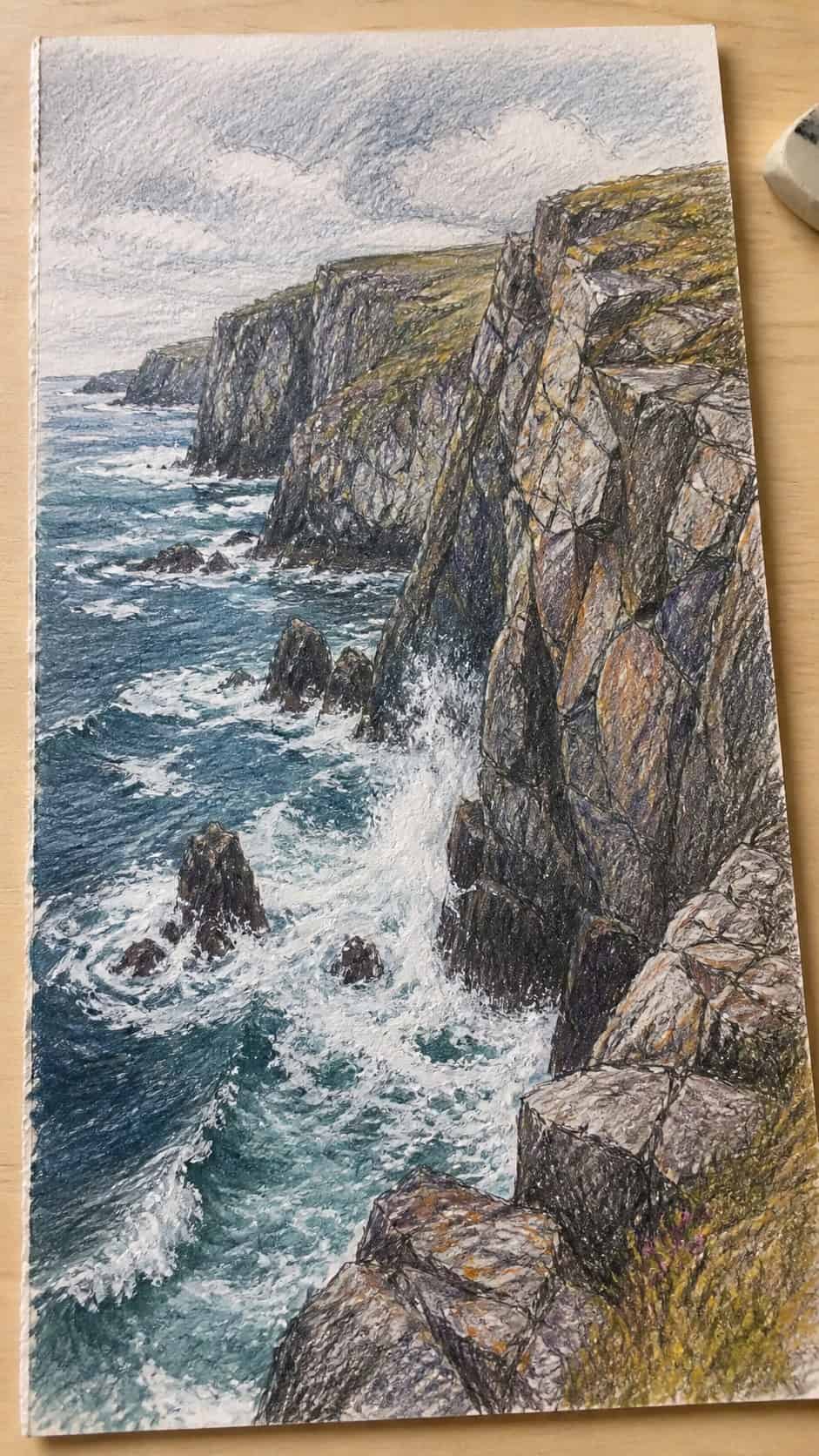 15 Landscape Drawing Ideas Worth Trying 24 Hand-drawn rocky coastal cliffs in colored-pencil and gouache drawing on textured paper, shown in a close overhead crop — study 3