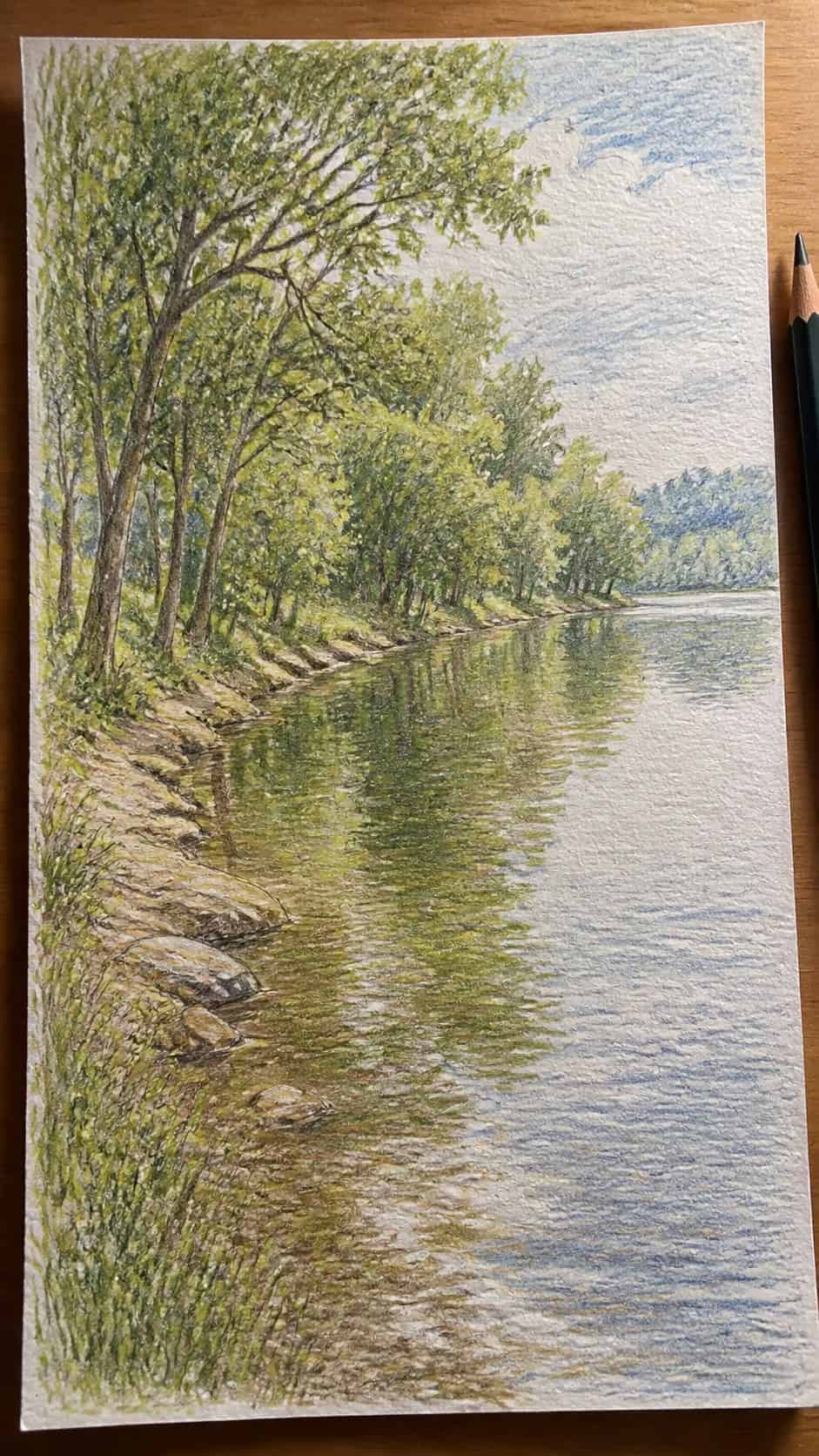 15 Landscape Drawing Ideas Worth Trying 32 Hand-drawn peaceful riverbank in colored-pencil and gouache drawing on textured paper, shown in a close overhead crop — study 2