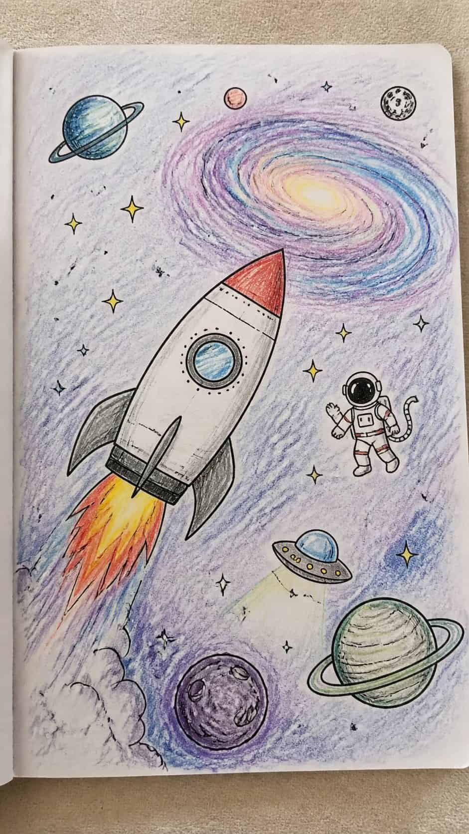 Discover the 15 Drawing Ideas Guaranteed to Unlock Your Child's Inner Picasso 5 Hand-drawn space adventures in colored-pencil drawing on textured paper, shown in a close overhead crop — study 1