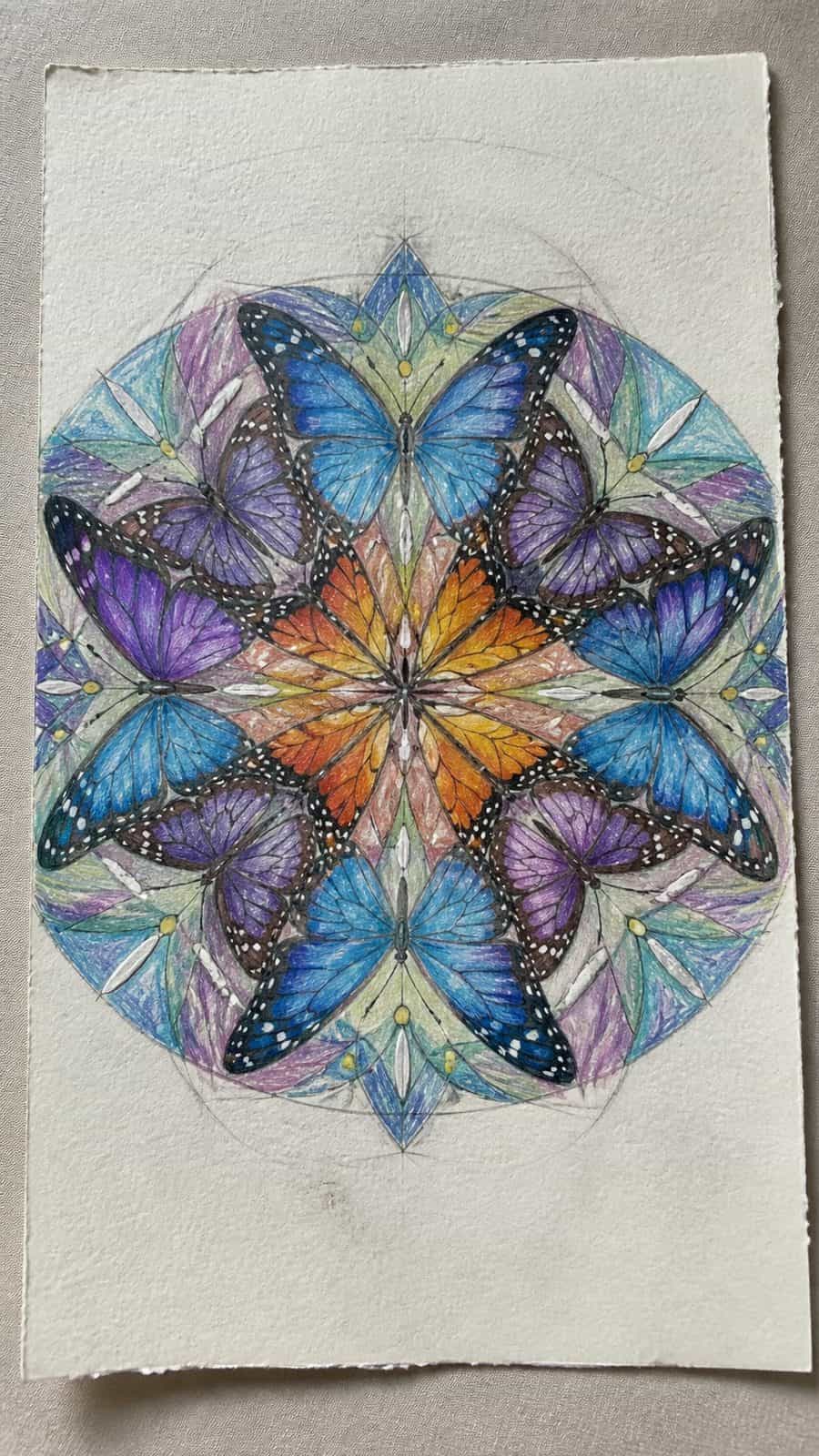 Bored of the Usual? Discover 16 Fresh Butterfly Drawing Concepts 17 Hand-drawn butterfly kaleidoscope in colored-pencil and gouache drawing on textured paper, shown in a slightly off-center overhead — study 2
