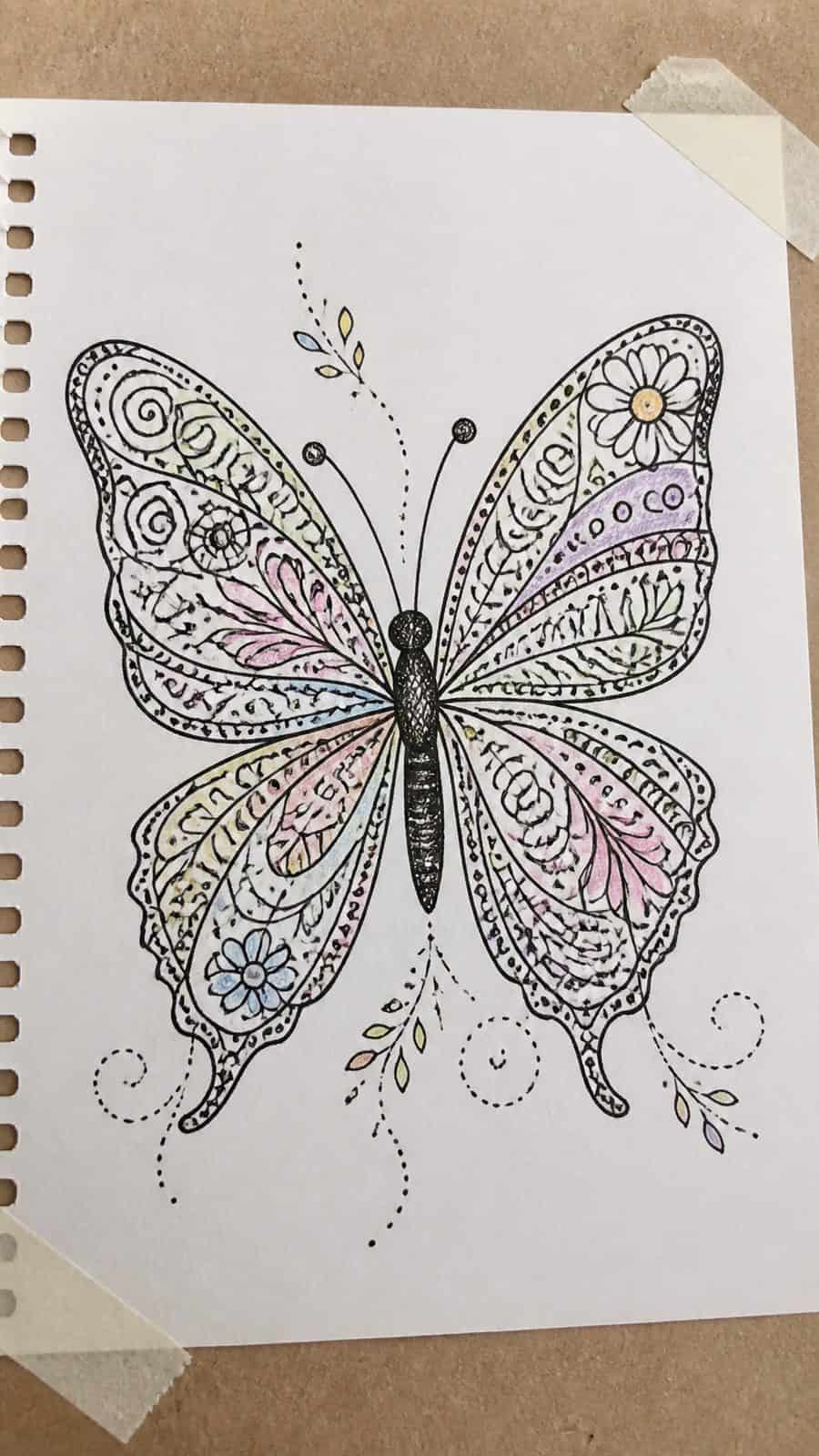 Bored of the Usual? Discover 16 Fresh Butterfly Drawing Concepts 24 Hand-drawn doodle butterfly in ink and colored-pencil drawing on textured paper, shown in a slightly off-center overhead composition — study 3