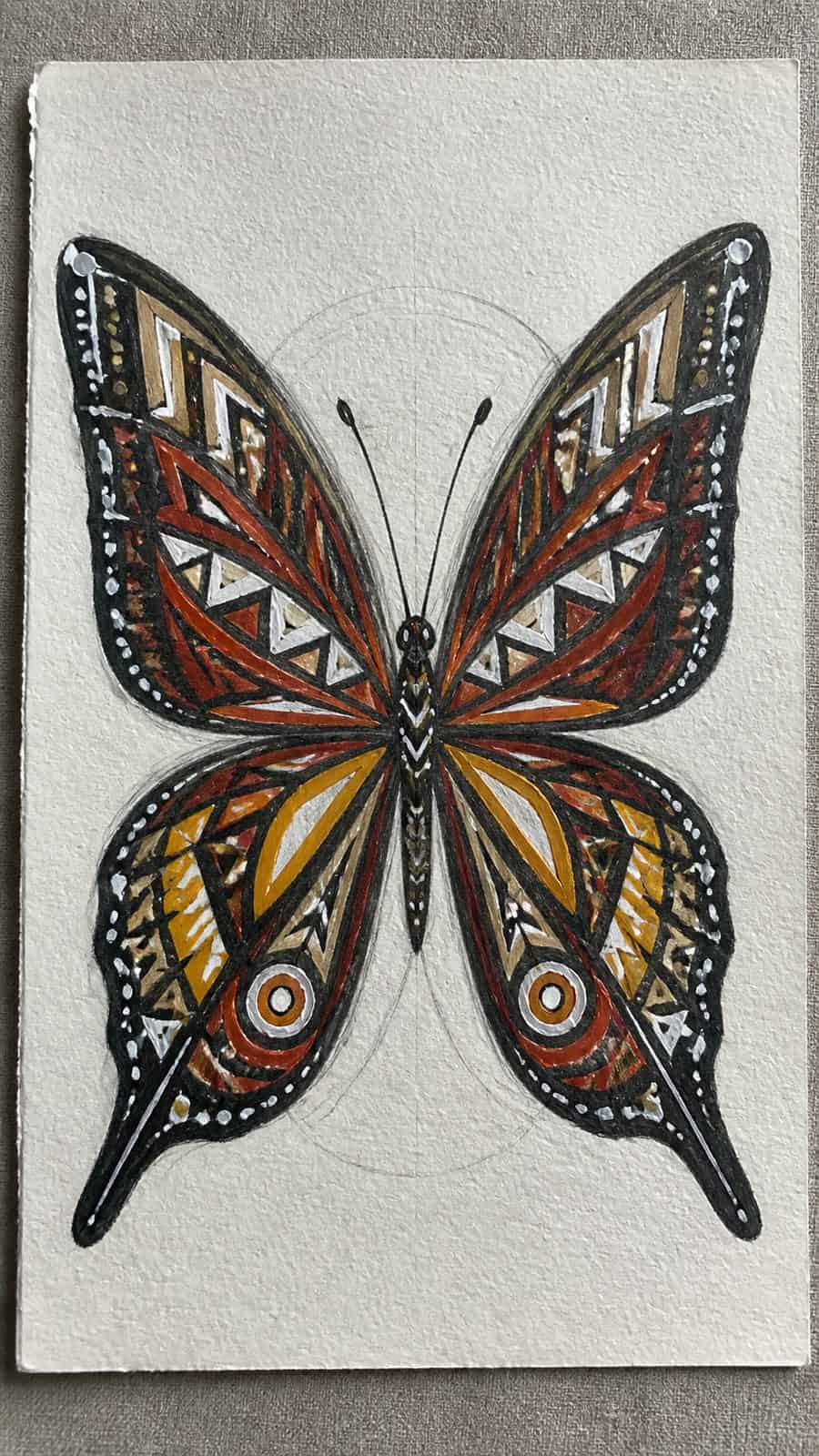 Bored of the Usual? Discover 16 Fresh Butterfly Drawing Concepts 27 Hand-drawn tribal pattern butterfly in colored-pencil and gouache drawing on textured paper, shown in a close overhead crop — study 1