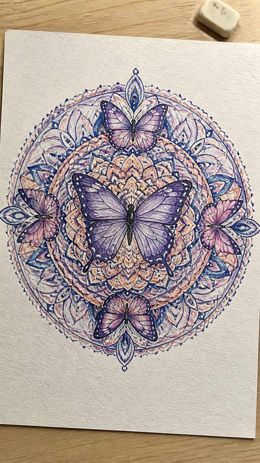 Bored of the Usual? Discover 16 Fresh Butterfly Drawing Concepts 40 Hand-drawn butterfly mandala in colored-pencil and gouache drawing on textured paper, shown in a slightly off-center overhead — study 2