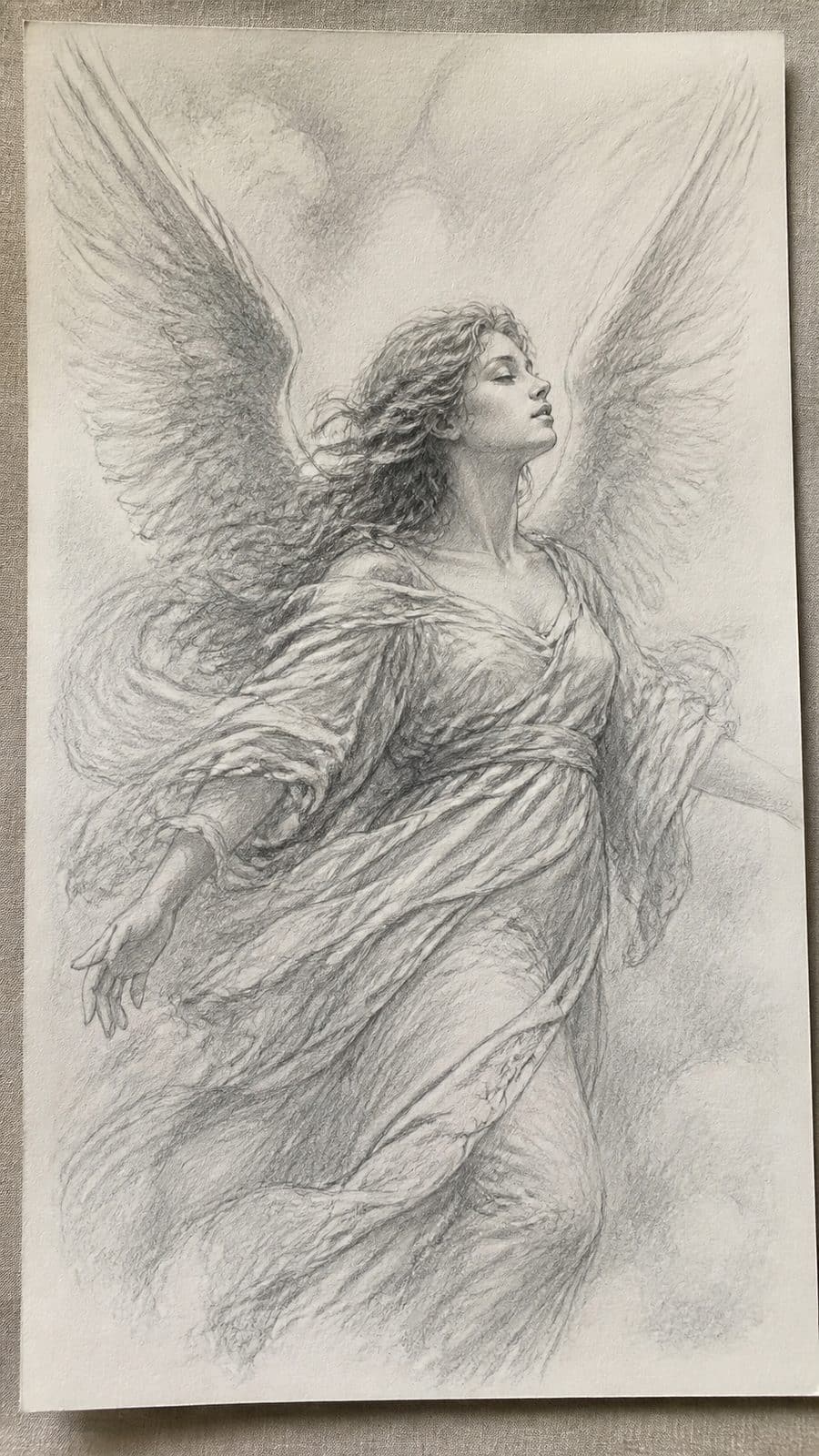 Heavenly Art: 17 God-Inspired Sketch Ideas to Awaken Your Creativity 3 Hand-drawn angelic visions in graphite drawing on textured paper, shown in a gentle oblique desk view that shows paper tooth and — study 2