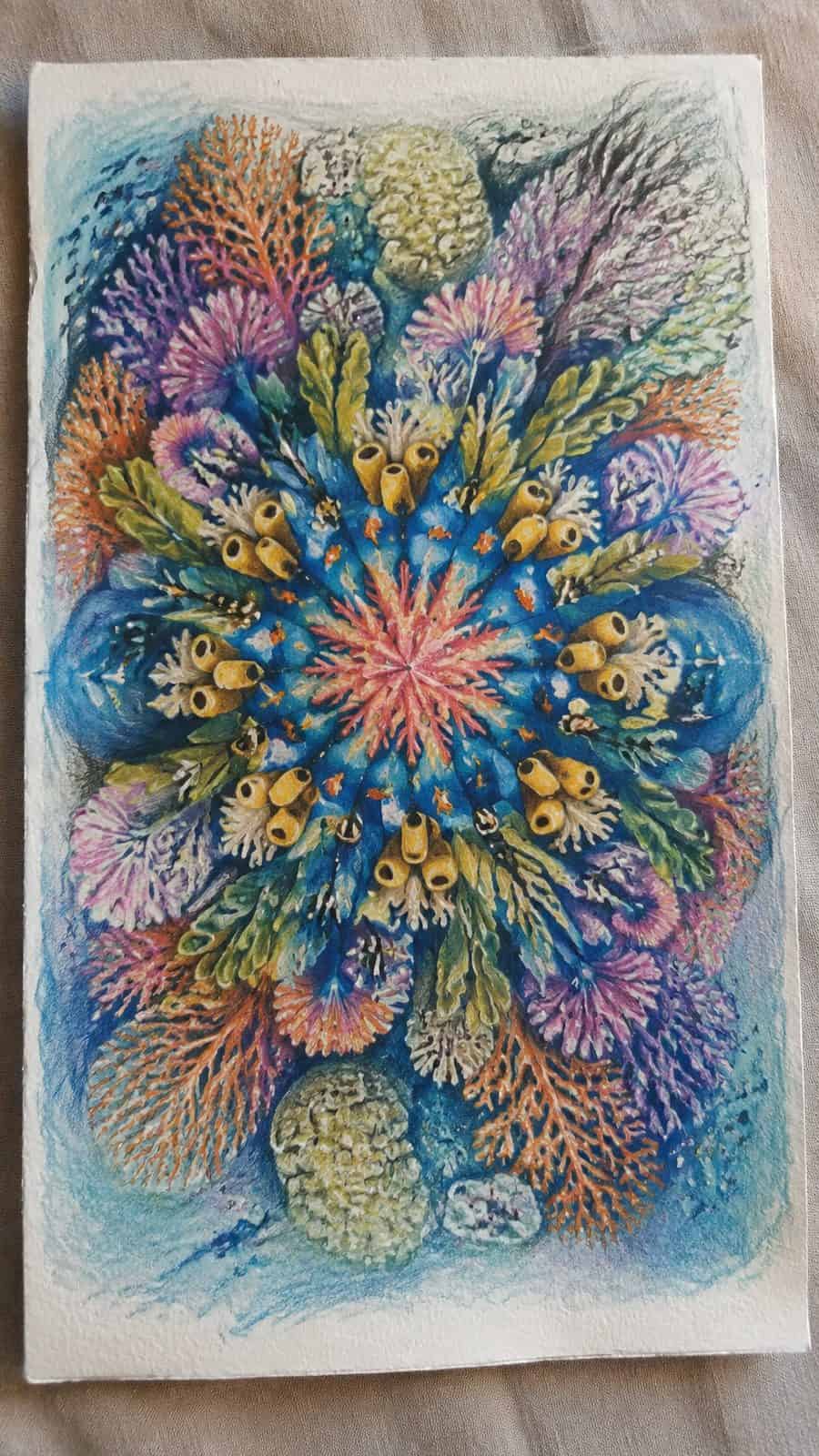Hand-drawn coral reef kaleidoscope in colored-pencil and gouache drawing on textured paper, shown in a slightly off-center overhead — study 1