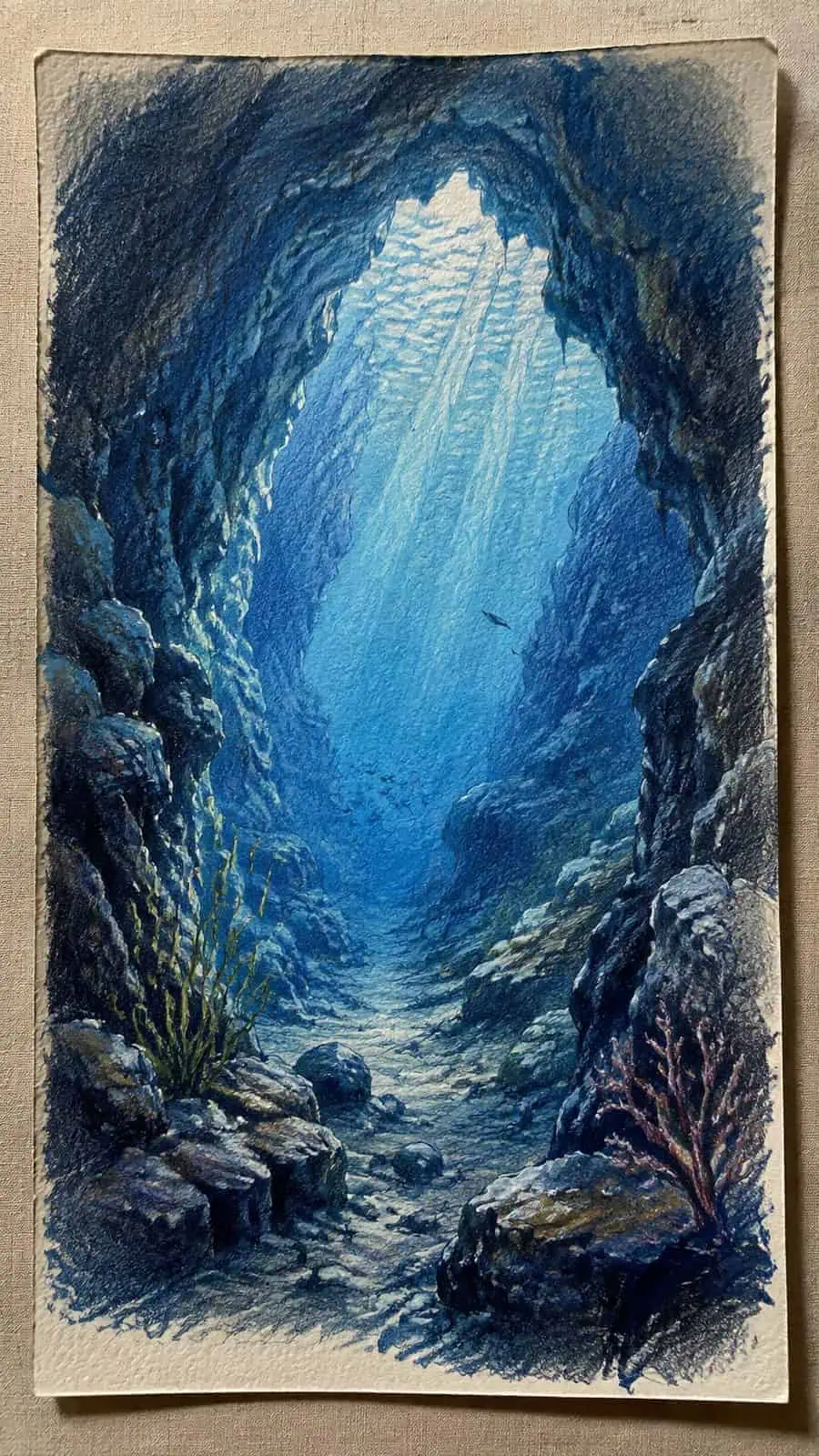 Hand-drawn silent underwater cave in colored-pencil and gouache drawing on textured paper, shown in a straight overhead view — study 2
