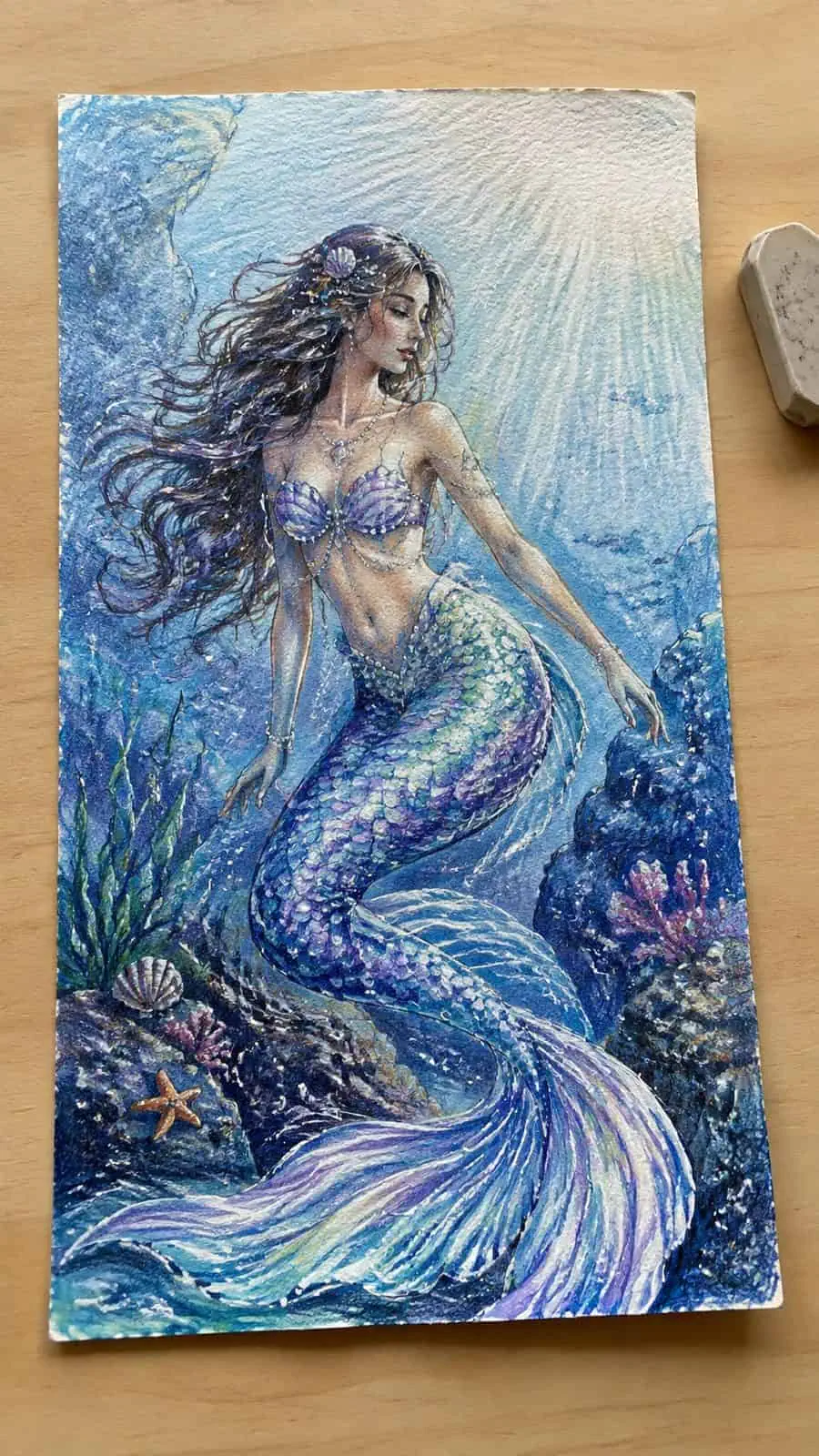 Hand-drawn glistening mermaid tale in colored-pencil and gouache drawing on textured paper, shown in a straight overhead view — study 2