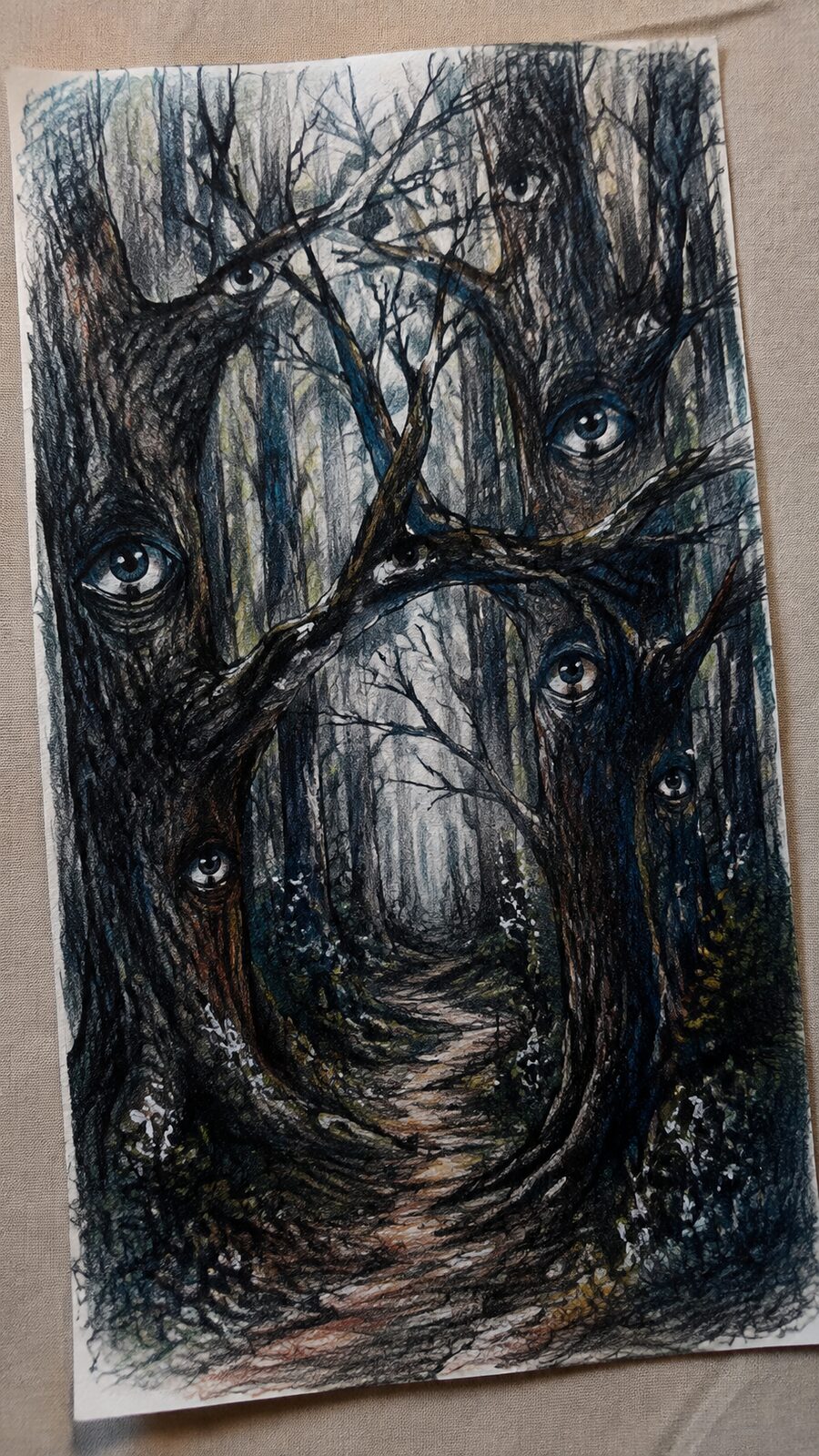 These 30 Trippy Drawing Ideas That Will Revolutionize Your Art 9 Hand-drawn eyes in the forest in colored-pencil drawing on textured paper, shown in a gentle oblique desk view that shows paper tooth — study 1