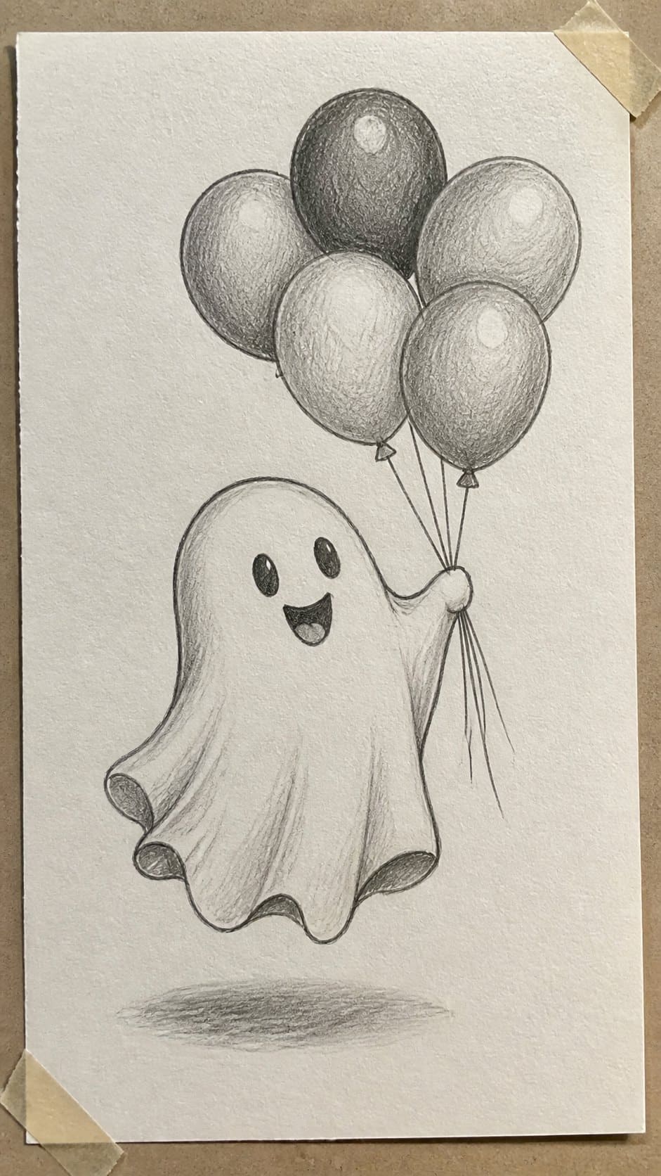 18 Ghost Drawing Ideas for Spooky and Expressive Sketches 12 Hand-drawn playful ghost with balloons in graphite drawing on textured paper, shown in a close overhead crop — study 1
