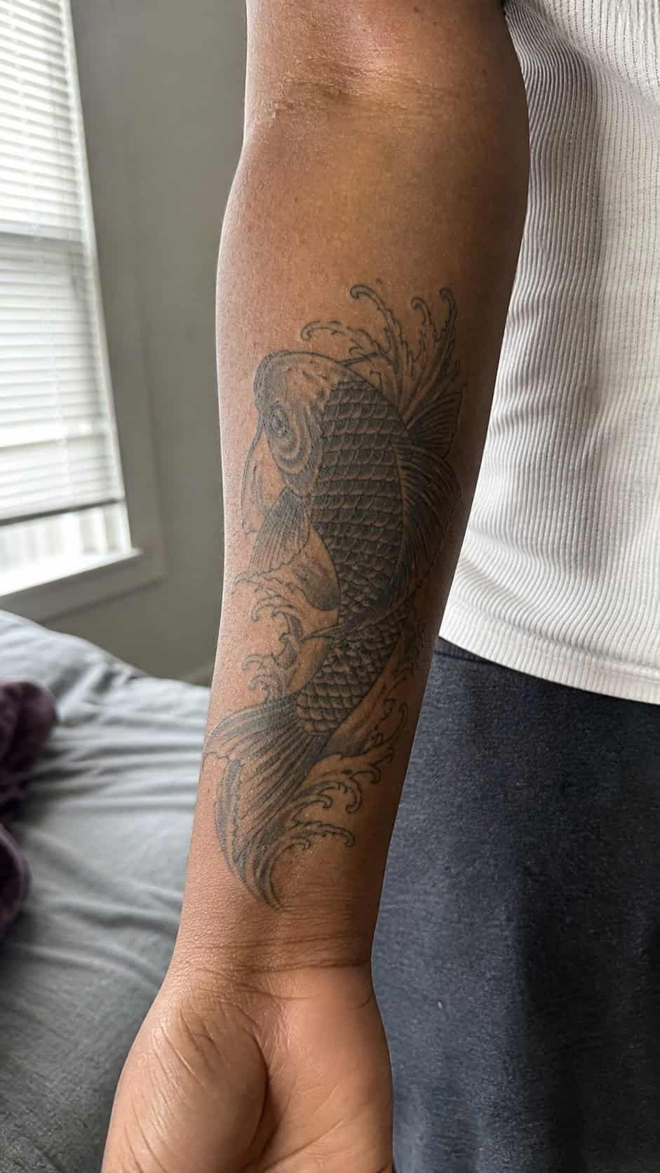 Empowering and Beautiful: 23 Japanese Tattoos for the Modern Woman 2 Healed the enchanting koi fish tattoo on a adult woman's inner forearm, photographed in a natural relaxed documentary crop — study 1