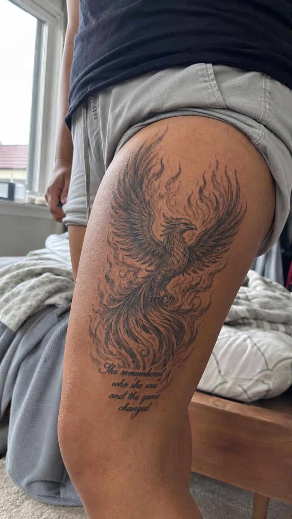 Empowering and Beautiful: 23 Japanese Tattoos for the Modern Woman 13 Healed breathtaking phoenix rising tattoo on a adult woman's outer thigh, photographed in a natural waist-height candid close-up — study 1
