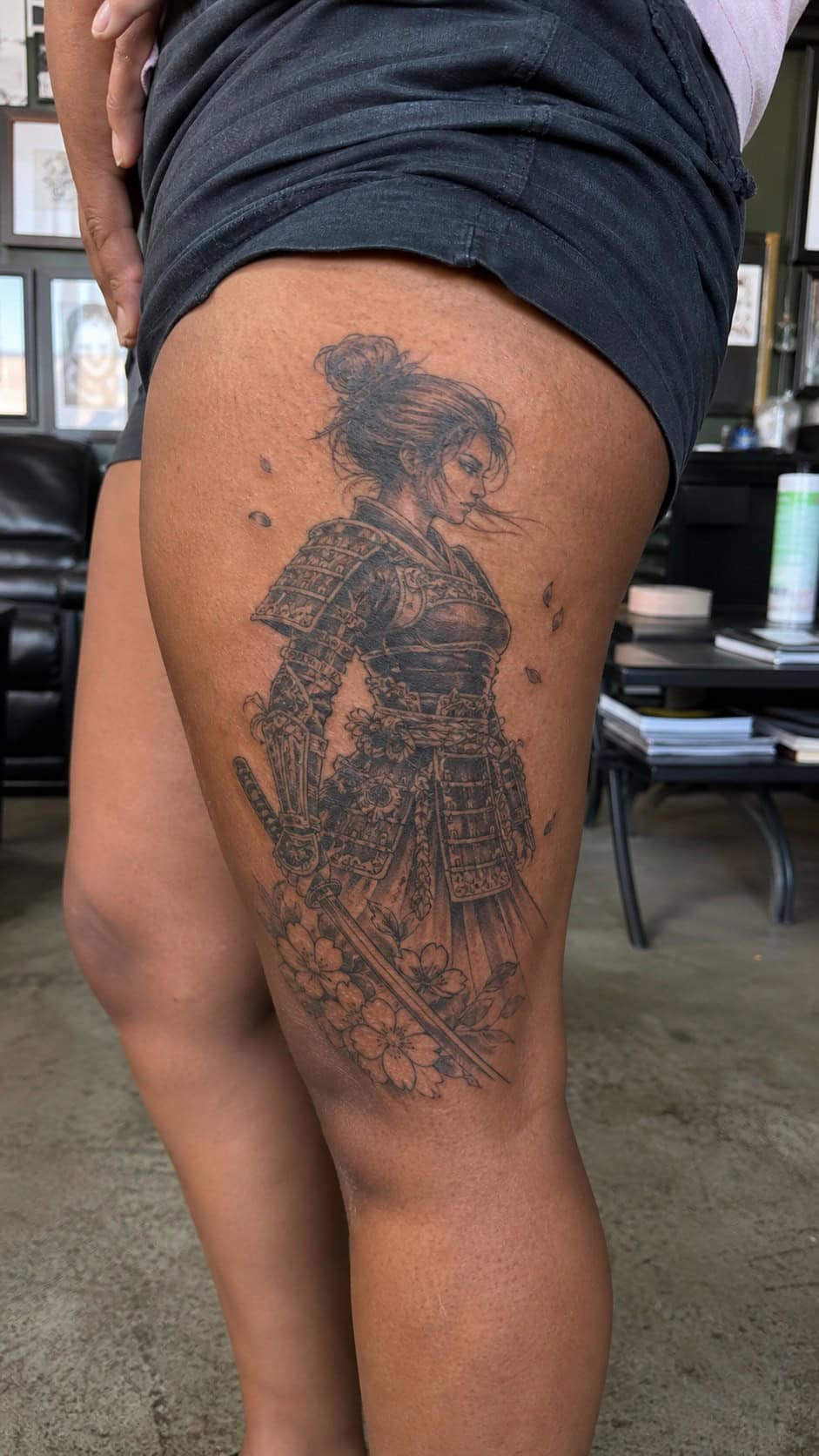 Empowering and Beautiful: 23 Japanese Tattoos for the Modern Woman 22 Healed samurai warrior spirit tattoo on a adult woman's outer thigh, photographed in a natural casual close three-quarter view — study 2