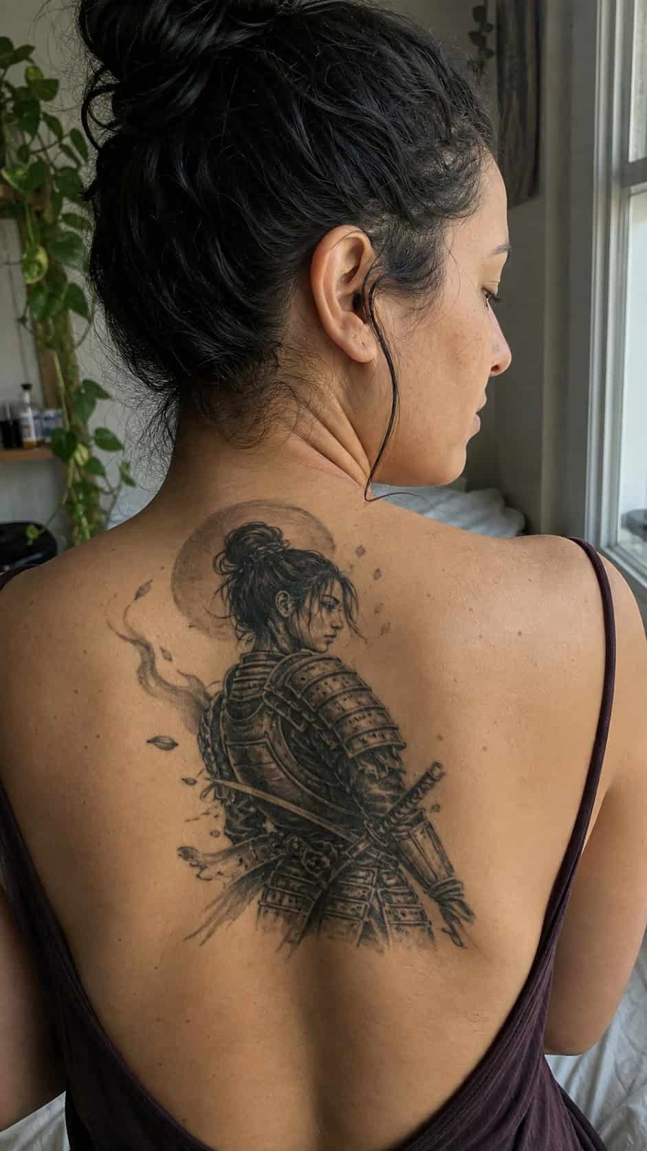 Empowering and Beautiful: 23 Japanese Tattoos for the Modern Woman 23 Healed samurai warrior spirit tattoo on a adult woman's upper back, photographed in a natural straight-on close view, a touch — study 3