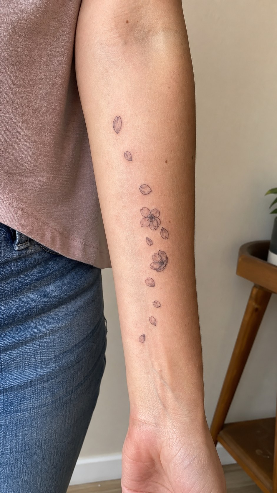 Empowering and Beautiful: 23 Japanese Tattoos for the Modern Woman 30 Healed sakura petal trail tattoo on a adult woman's inner forearm, photographed in a natural straight-on close view, a touch — study 1