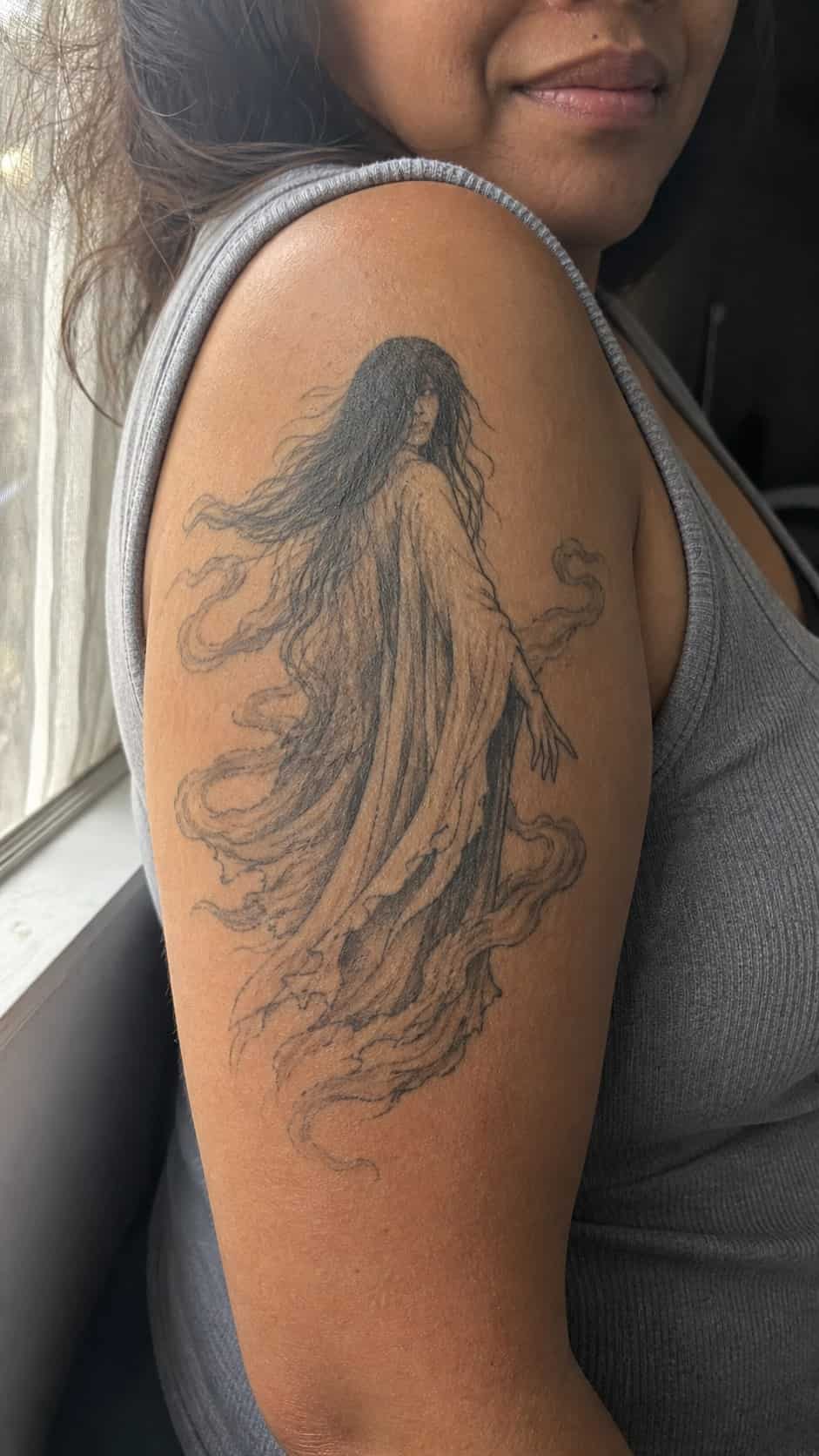 Empowering and Beautiful: 23 Japanese Tattoos for the Modern Woman 37 Healed hauntingly beautiful ghost tattoo on a adult woman's outer upper arm, photographed in a natural relaxed documentary crop — study 2