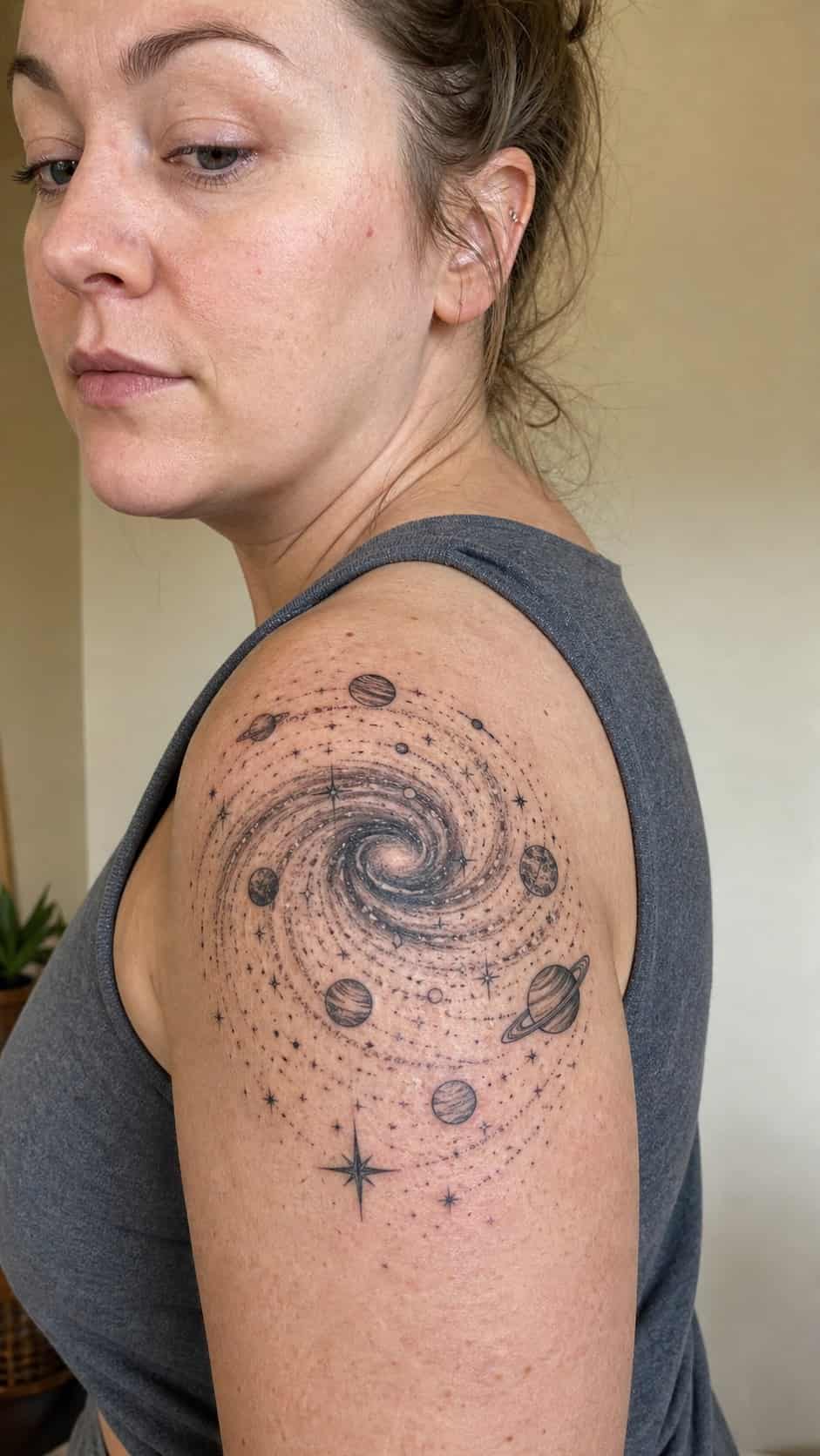 38 Creative Tattoo Ideas for Women 10 Healed cosmic galaxy tattoo on a adult woman's shoulder, photographed in a natural casual close three-quarter view — study 1