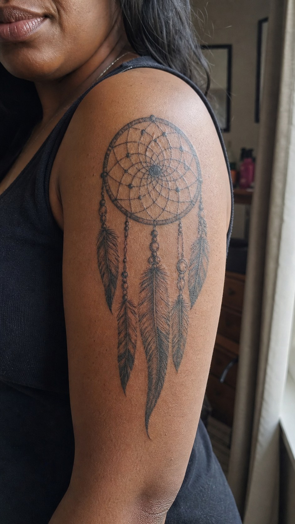 38 Creative Tattoo Ideas for Women 14 Healed dreamcatcher tattoo on a adult woman's outer upper arm, photographed in a natural straight-on close view, a touch off-center — study 2