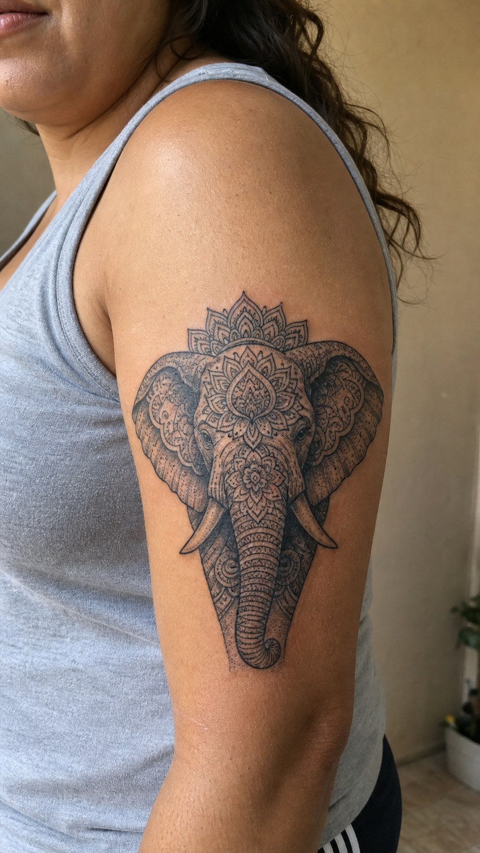 38 Creative Tattoo Ideas for Women 18 Healed mandala elephant tattoo on a adult woman's outer upper arm, photographed in a natural slightly elevated close view — study 2