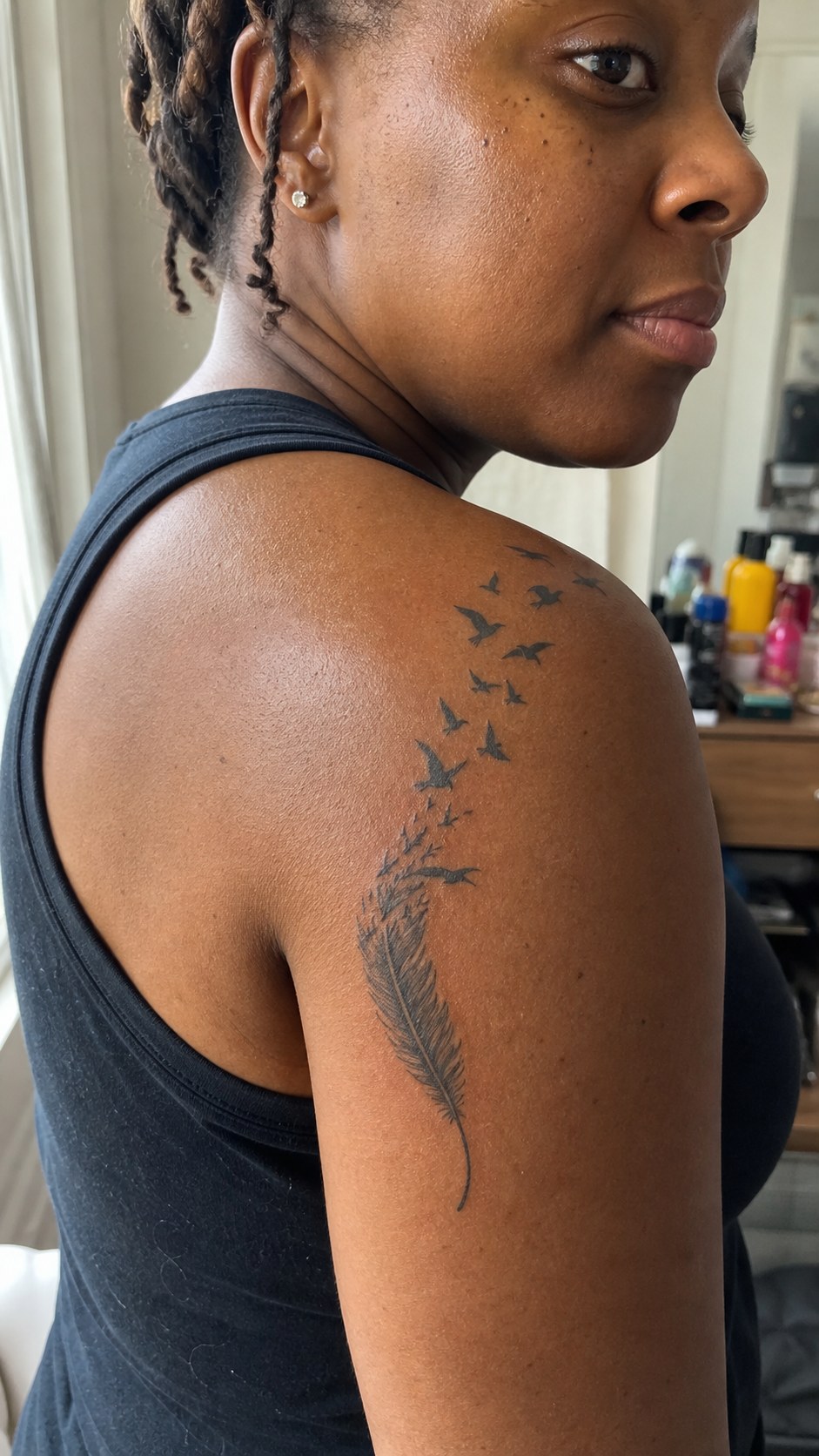 38 Creative Tattoo Ideas for Women 20 Healed feather with birds tattoo on a adult woman's shoulder, photographed in a natural casual close three-quarter view — study 2